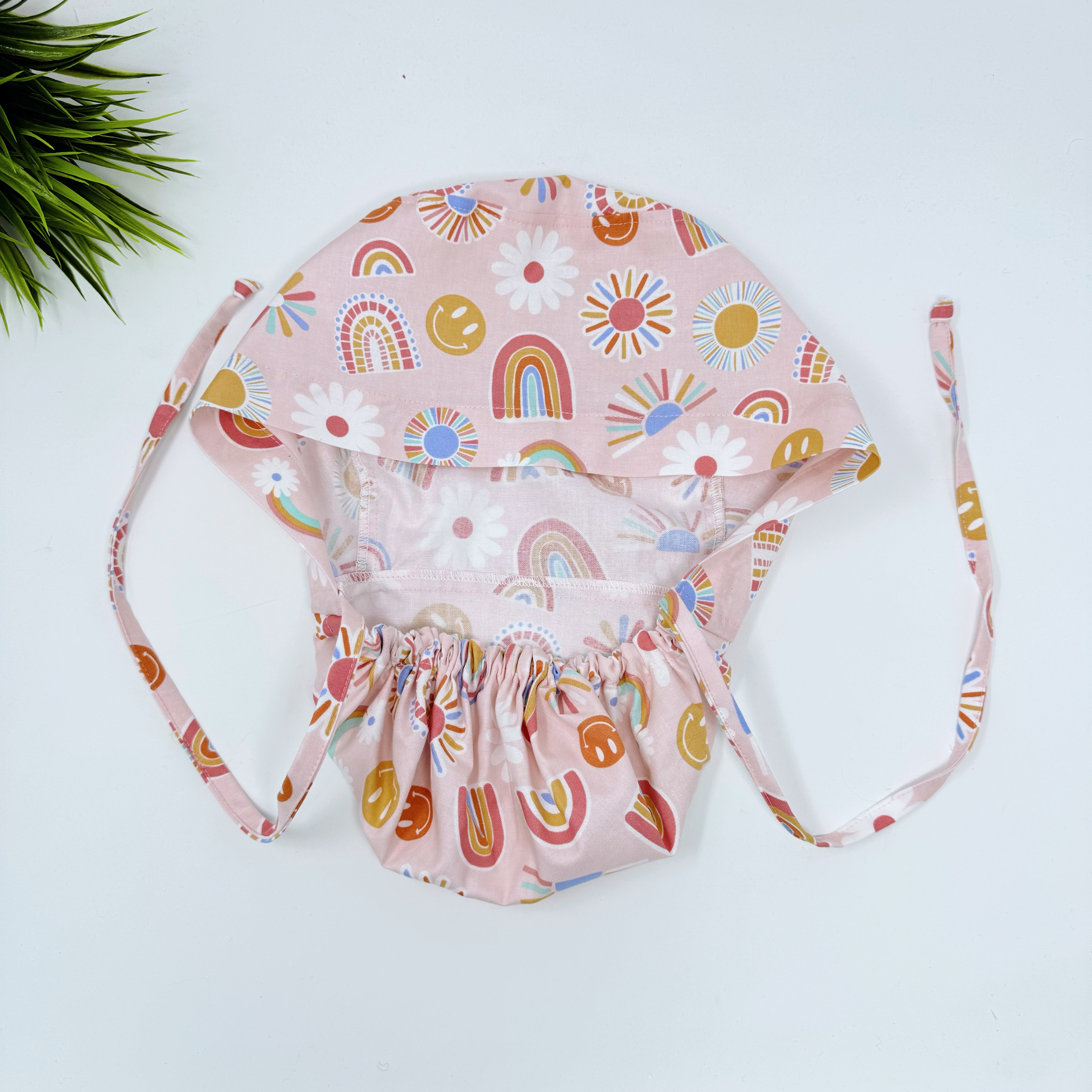 Rainbows Ponytail scrub cap for women with satin lined option by Paradise Caps.