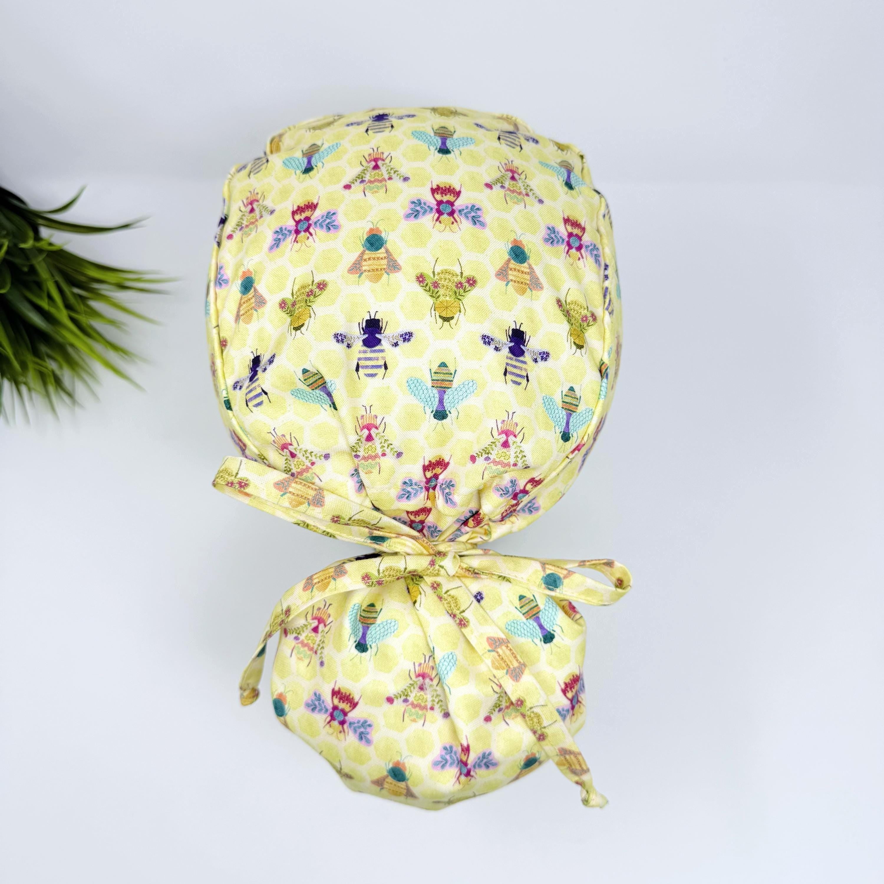 Bee Ponytail scrub cap for women with satin lined option, Yellow Surgical cap with ponytail by Paradise Caps.