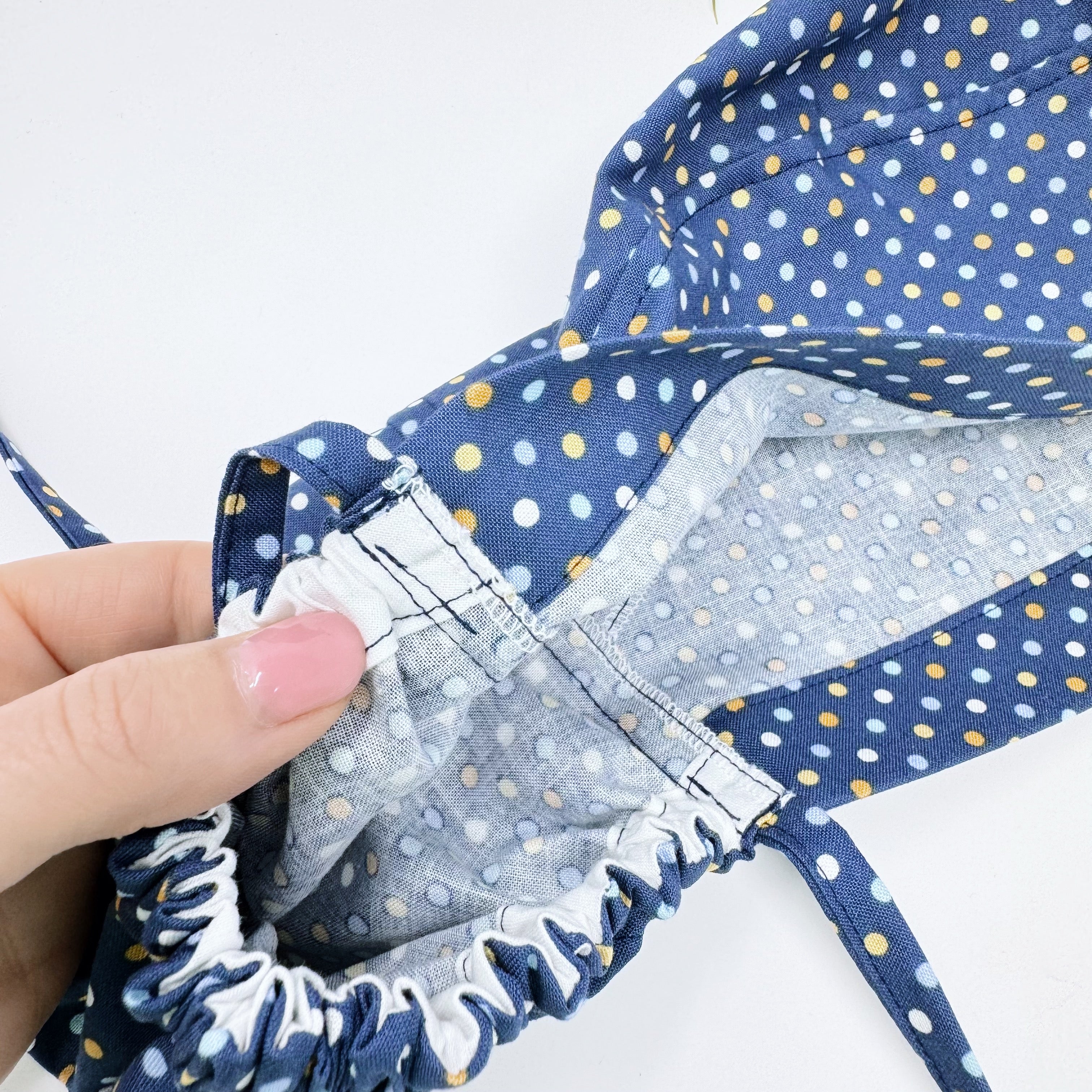 Navy Polka Dot Ponytail scrub cap for women with satin lined option by Paradise Caps.