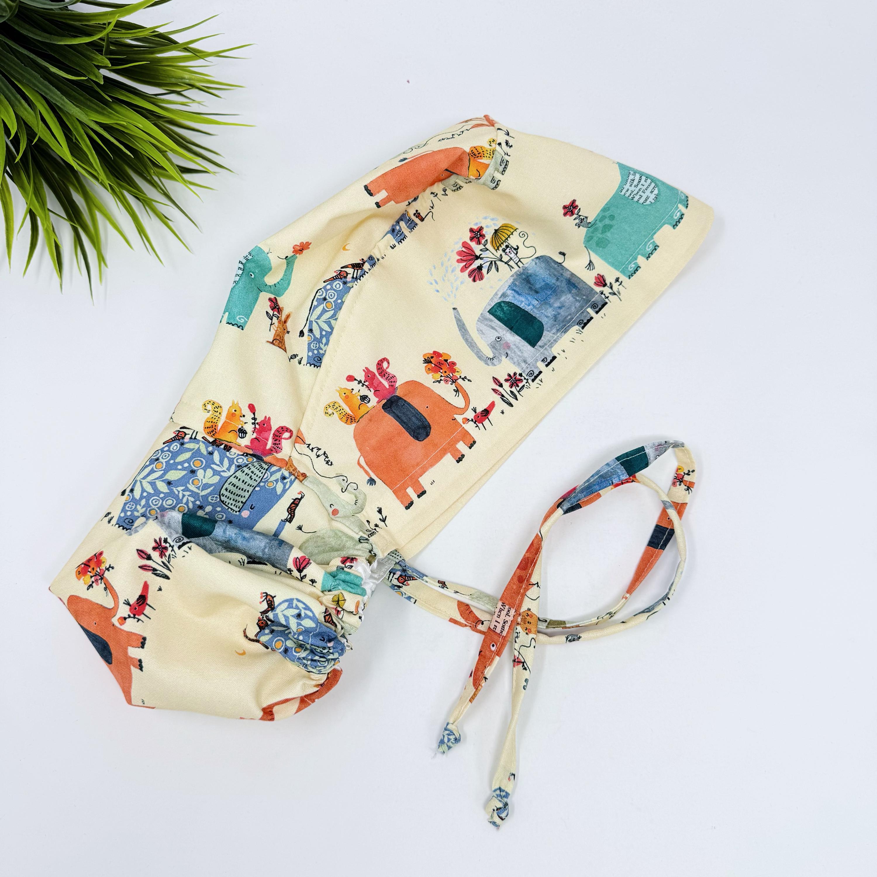 Elephant Ponytail scrub cap for women. Jungle Surgical hat with satin lined option by Paradise Caps.