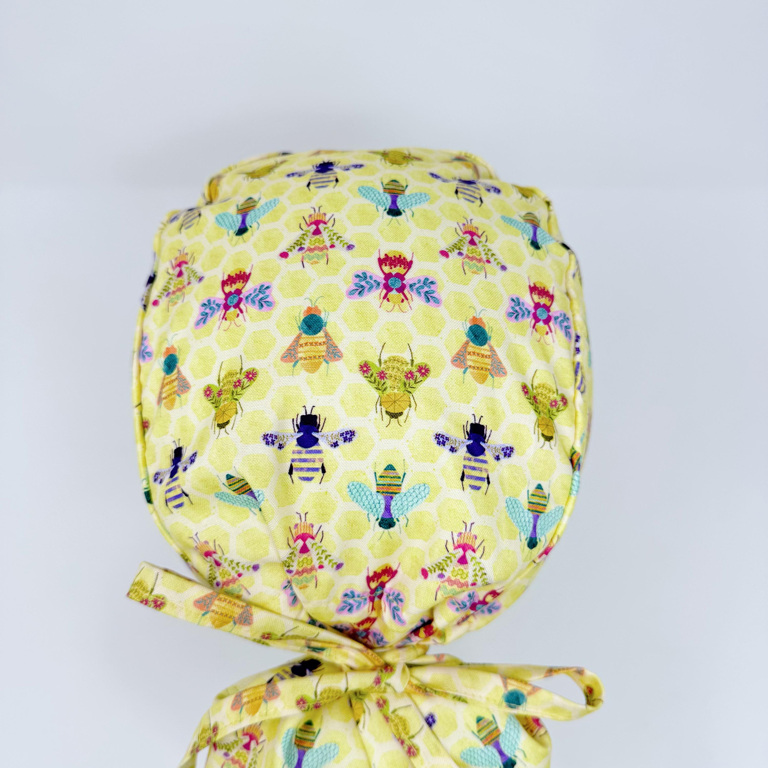 Bee Ponytail scrub cap for women with satin lined option, Yellow Surgical cap with ponytail by Paradise Caps.