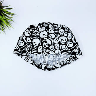 Tossed Skulls Skull tie-back style surgical scrub cap for men by Paradise Caps. Glows in the Dark!