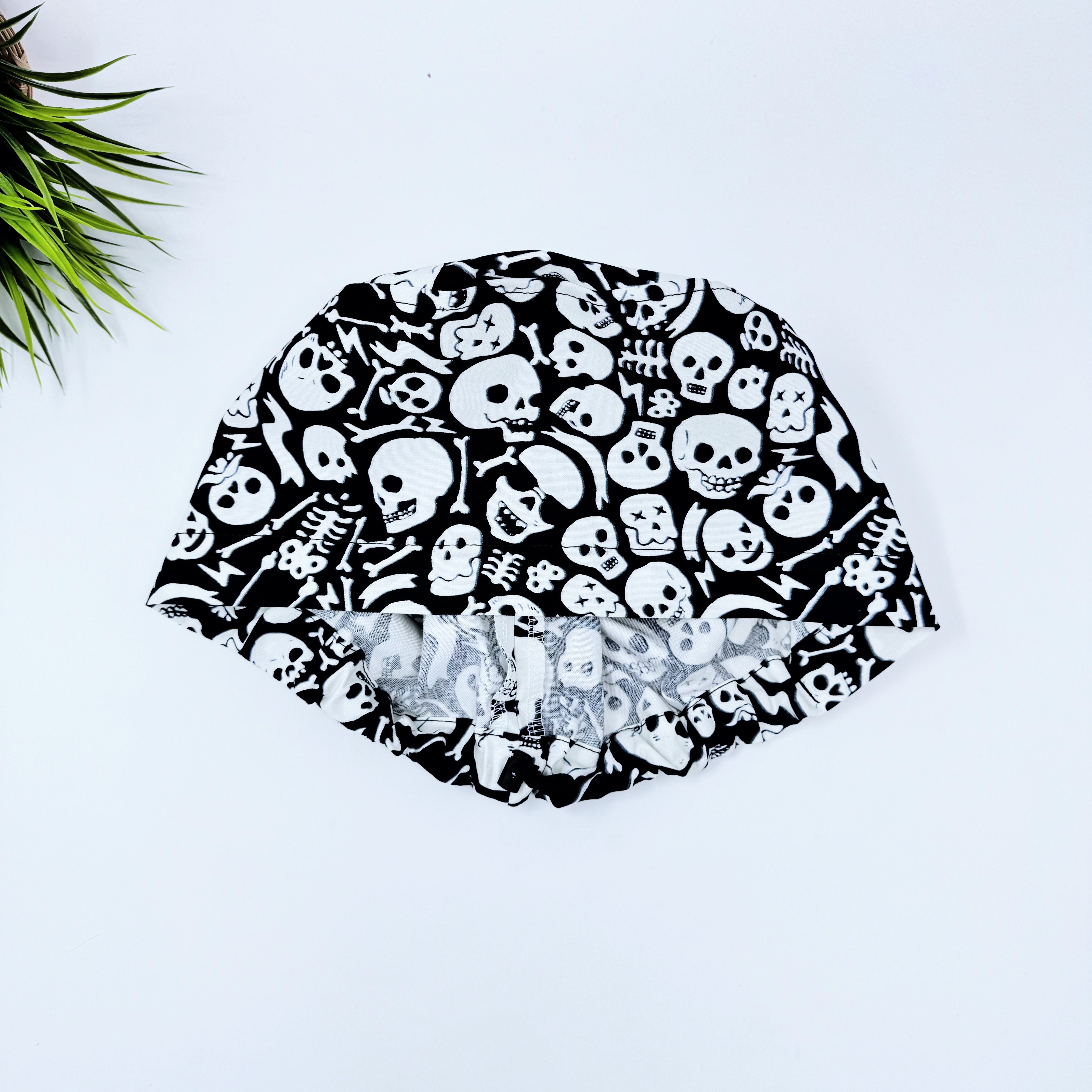 Tossed Skulls Skull tie-back style surgical scrub cap for men by Paradise Caps. Glows in the Dark!