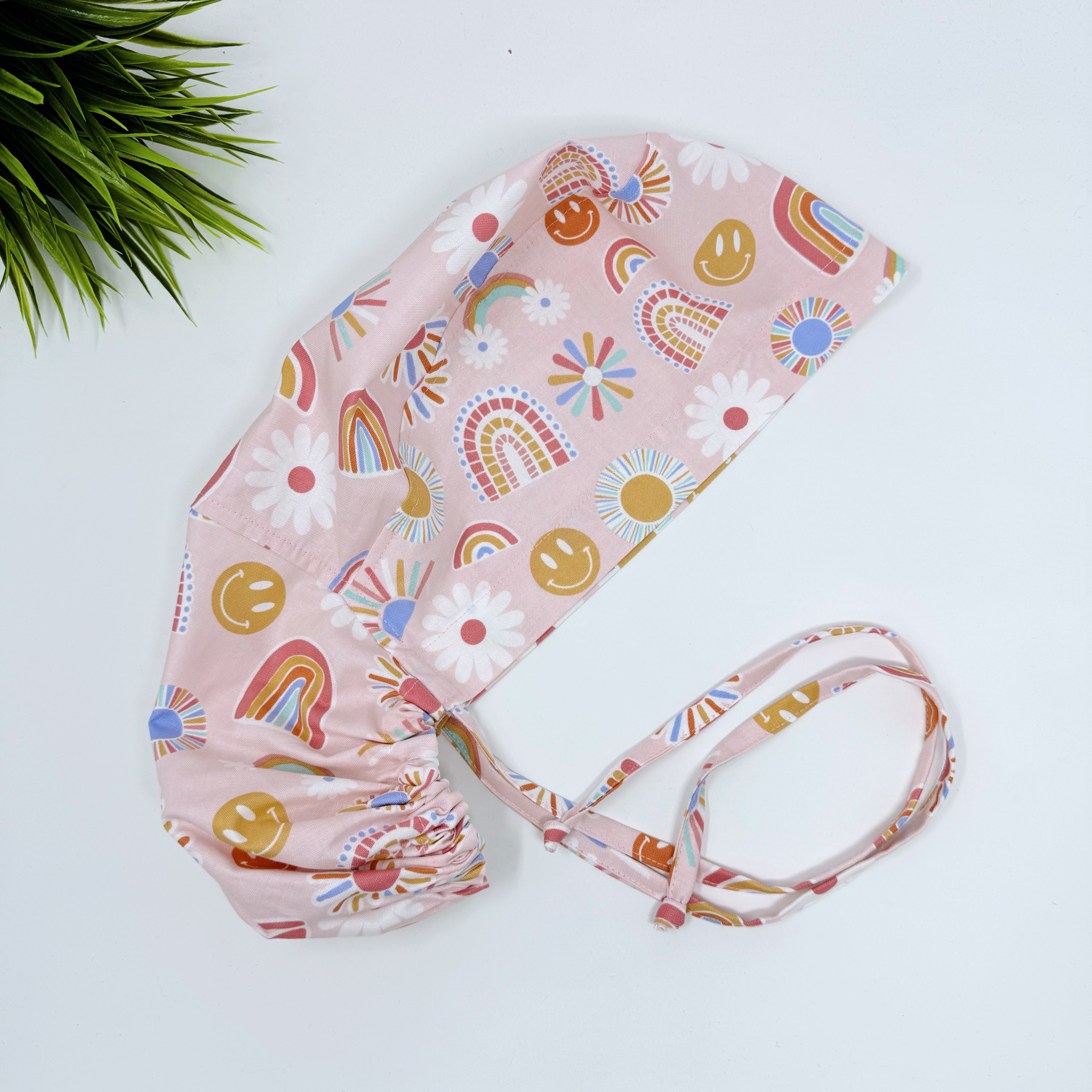 Rainbows Ponytail scrub cap for women with satin lined option by Paradise Caps.