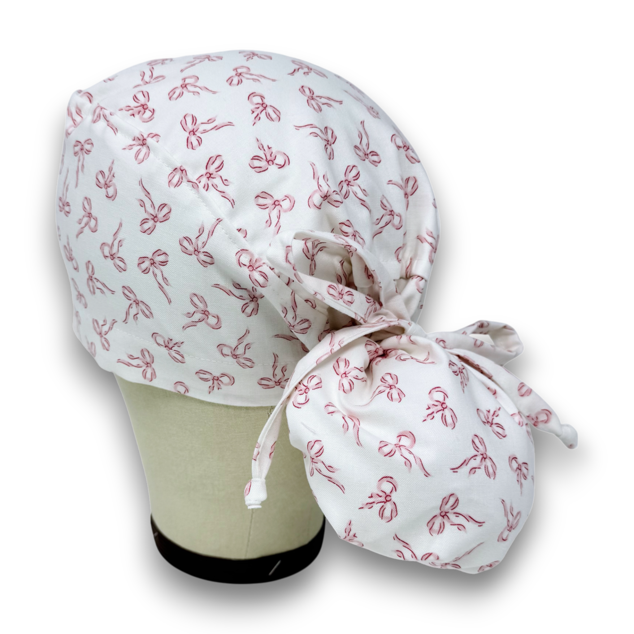 Pink Bows Ponytail scrub cap with satin lined. Bow Print surgical cap for women by Paradise Caps.