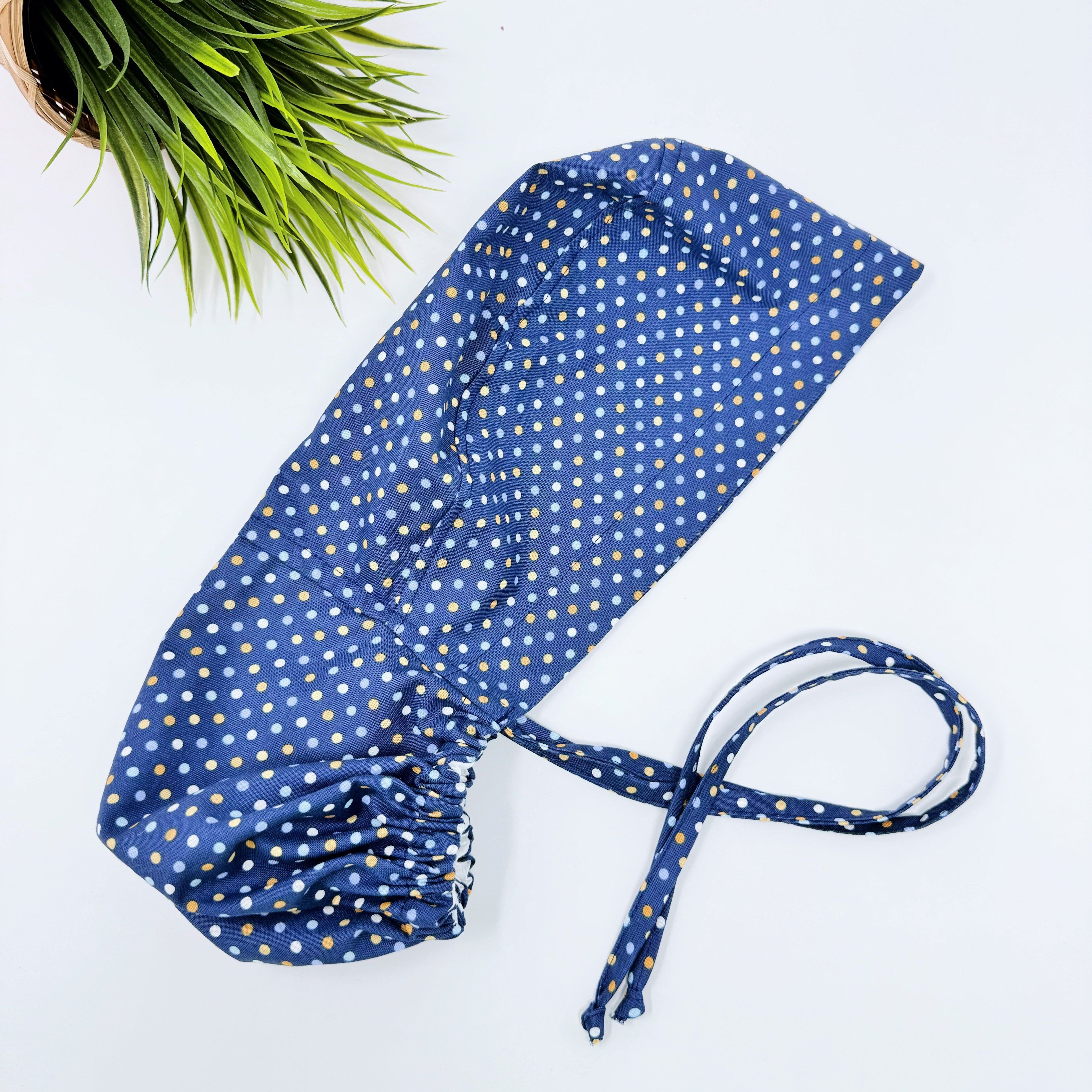 Navy Polka Dot Ponytail scrub cap for women with satin lined option by Paradise Caps.