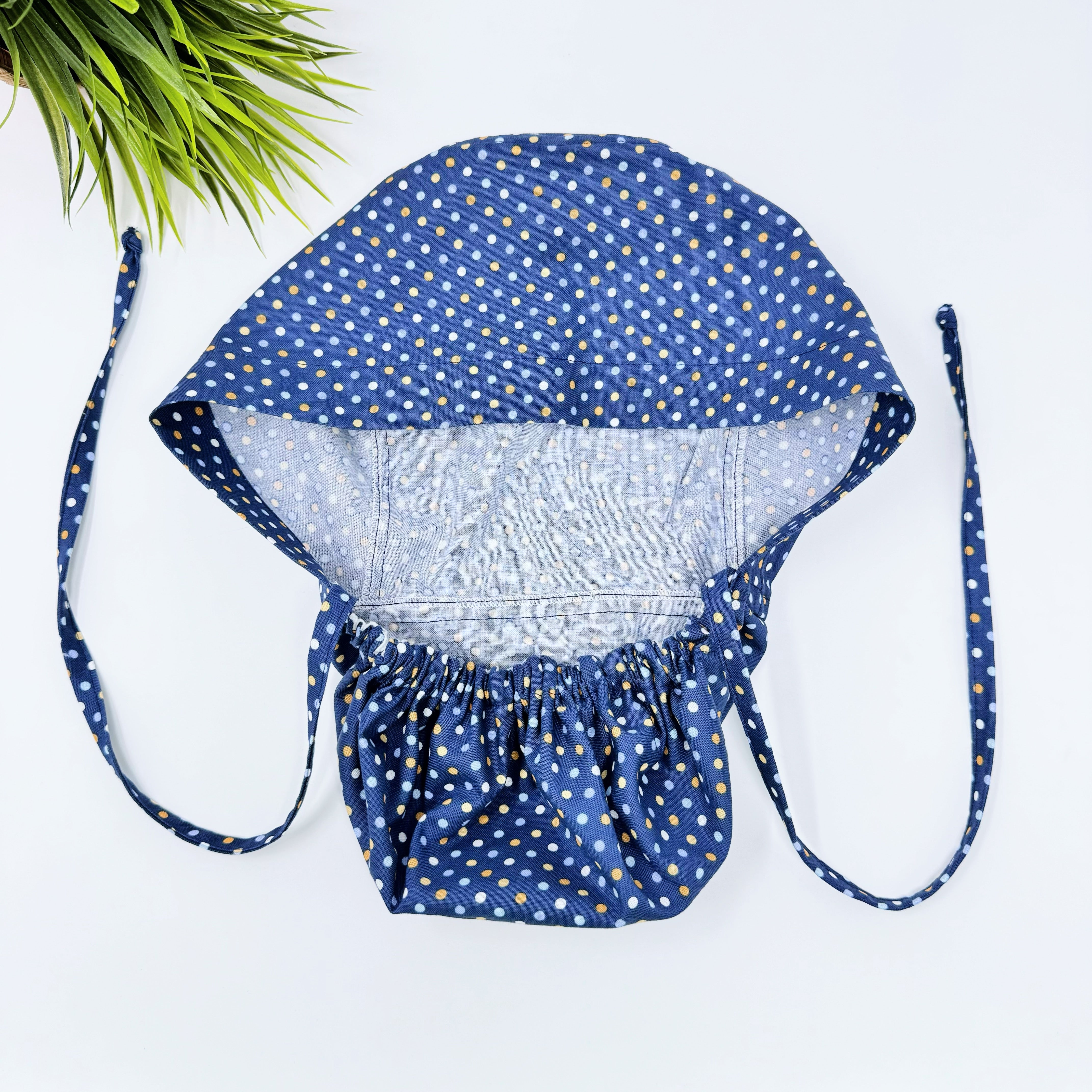 Navy Polka Dot Ponytail scrub cap for women with satin lined option by Paradise Caps.