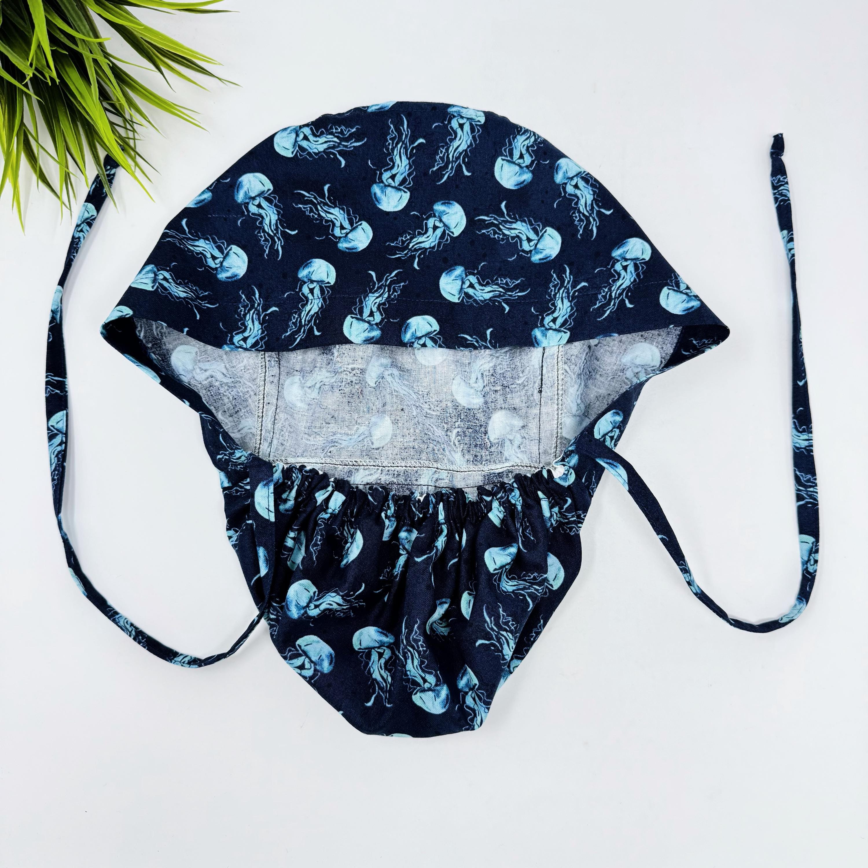 Jellyfish ponytail scrub cap women. Navy Blue Ocean Print Satin Lined option Ponytail scrub hat. Scrub caps for women by Paradise Caps.