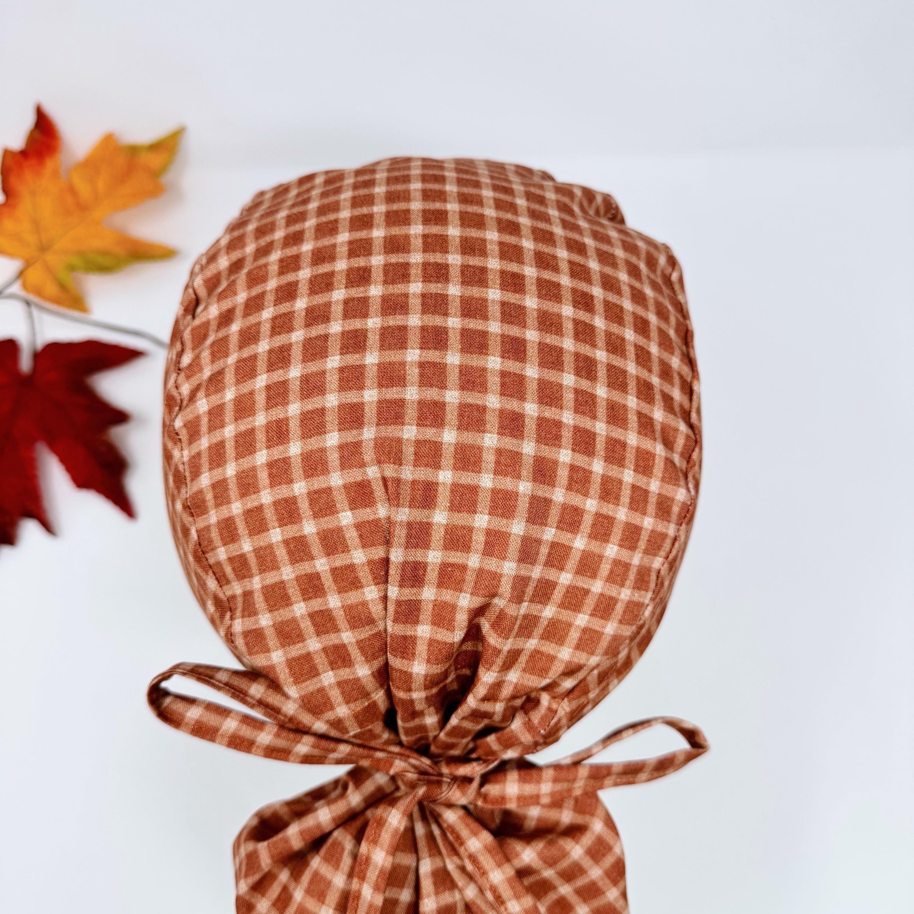Rustic Check Ponytail scrub cap for women. Rust Surgical cap with ponytail, satin lined option by Paradise Caps.