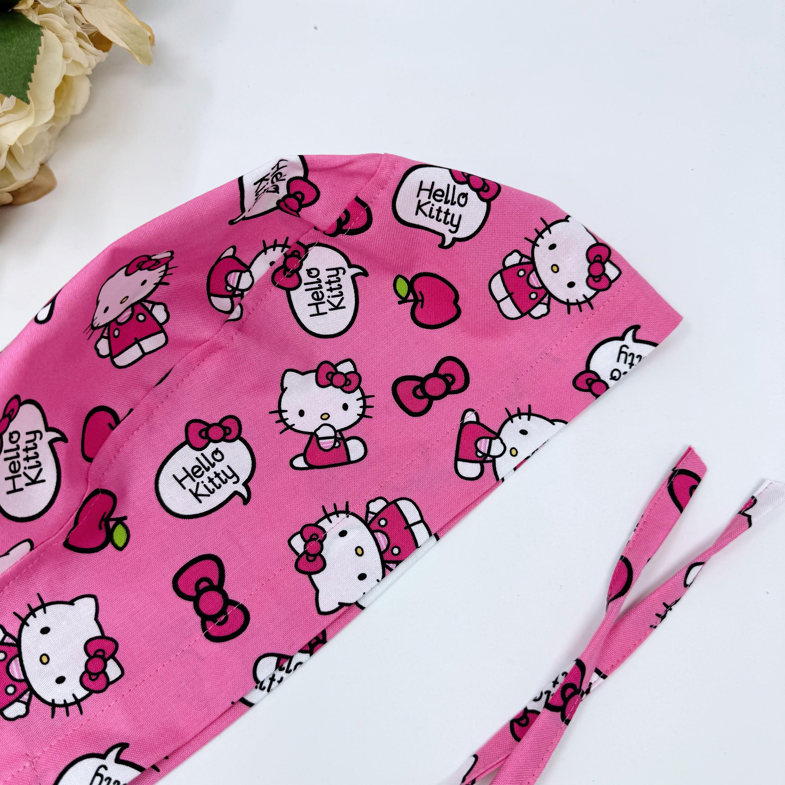 Pink surgical cap. Kitty skull tie-back style scrub cap with satin lined option by Paradise Caps.