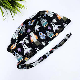 Men's surgical scrub cap. Black Space Rocket Print skull tie-back style scrub hat by Paradise Caps.