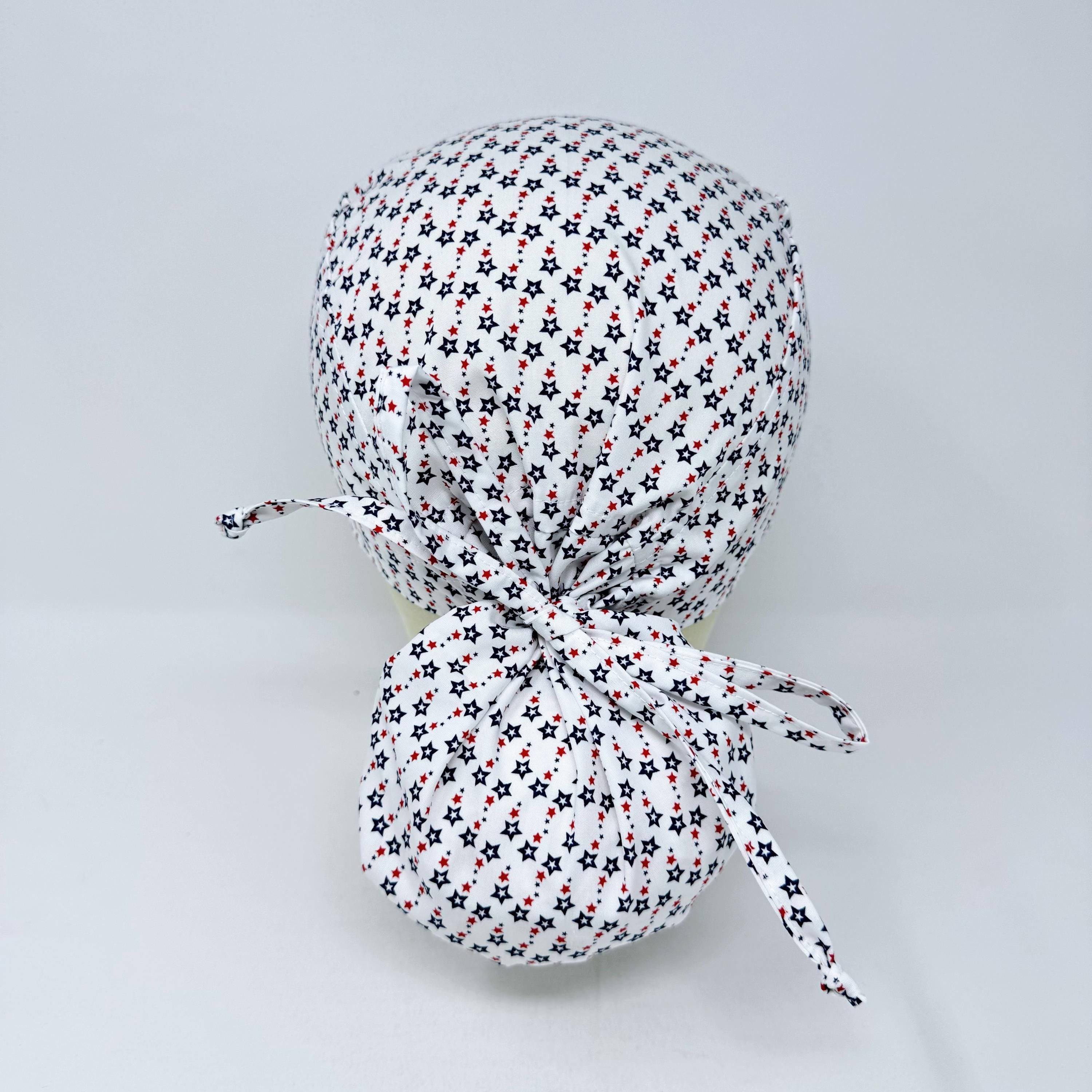 Ponytail scrub cap for women with satin lined option. Patriotic Stars Surgical hat with ponytail by Paradise Caps.