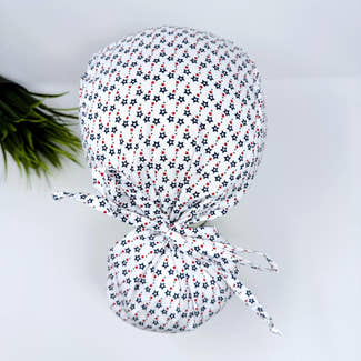 Ponytail scrub cap for women with satin lined option. Patriotic Stars Surgical hat with ponytail by Paradise Caps.