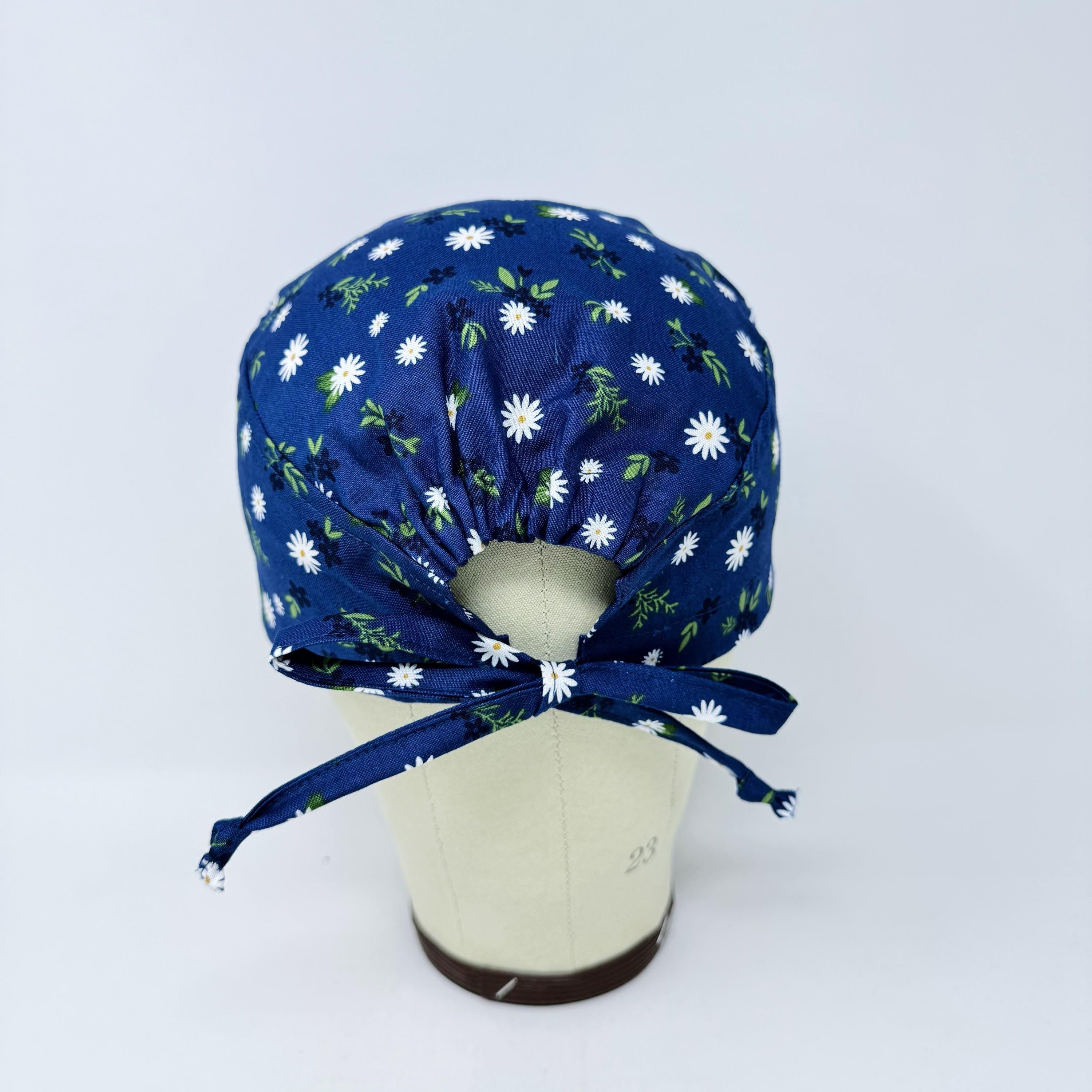 Navy Daisy Skull tie-back style surgical scrub cap by Paradise Caps.