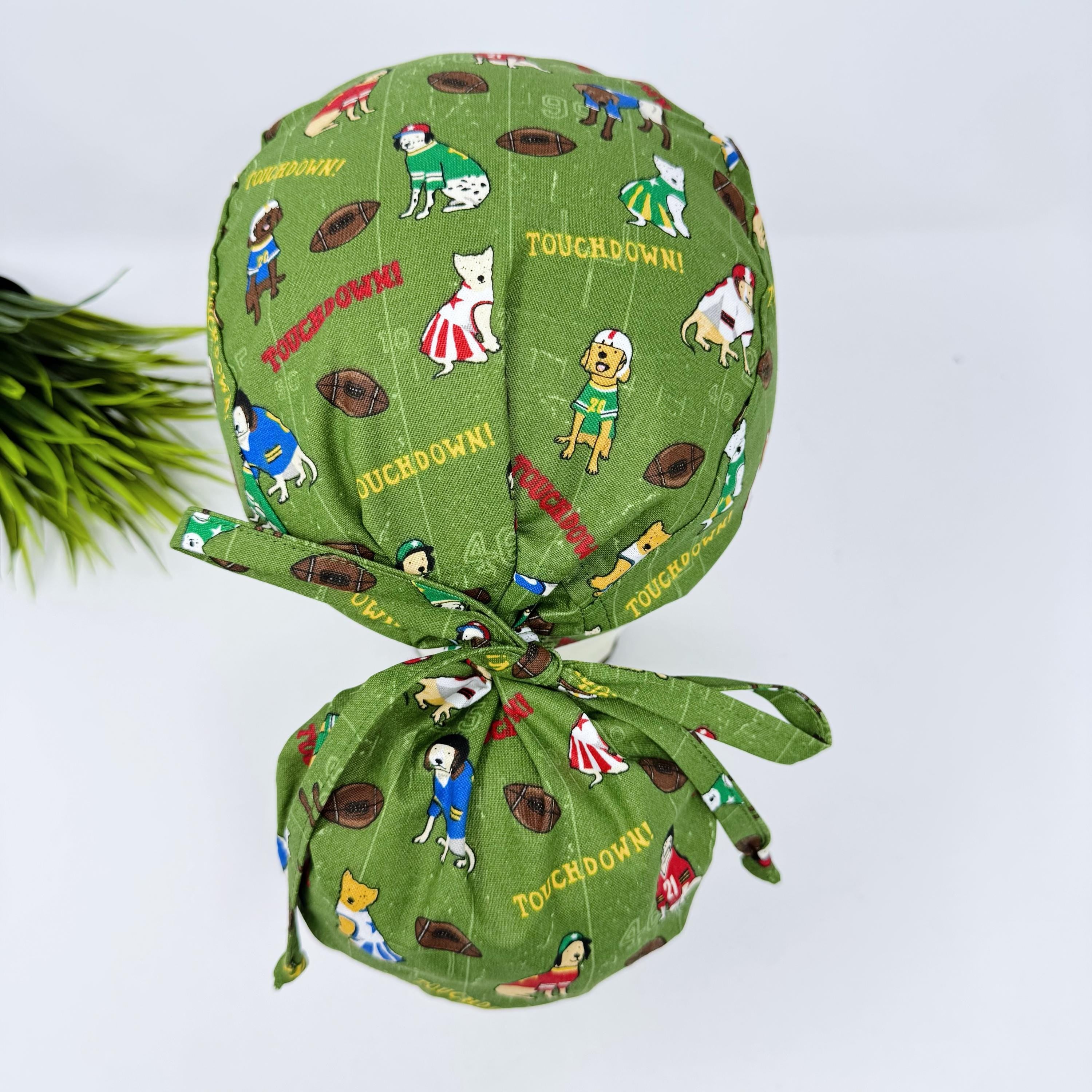 Ponytail scrub cap by Paradise Caps. Football Dogs surgical hat for women.