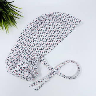 Ponytail scrub cap for women with satin lined option. Patriotic Stars Surgical hat with ponytail by Paradise Caps.