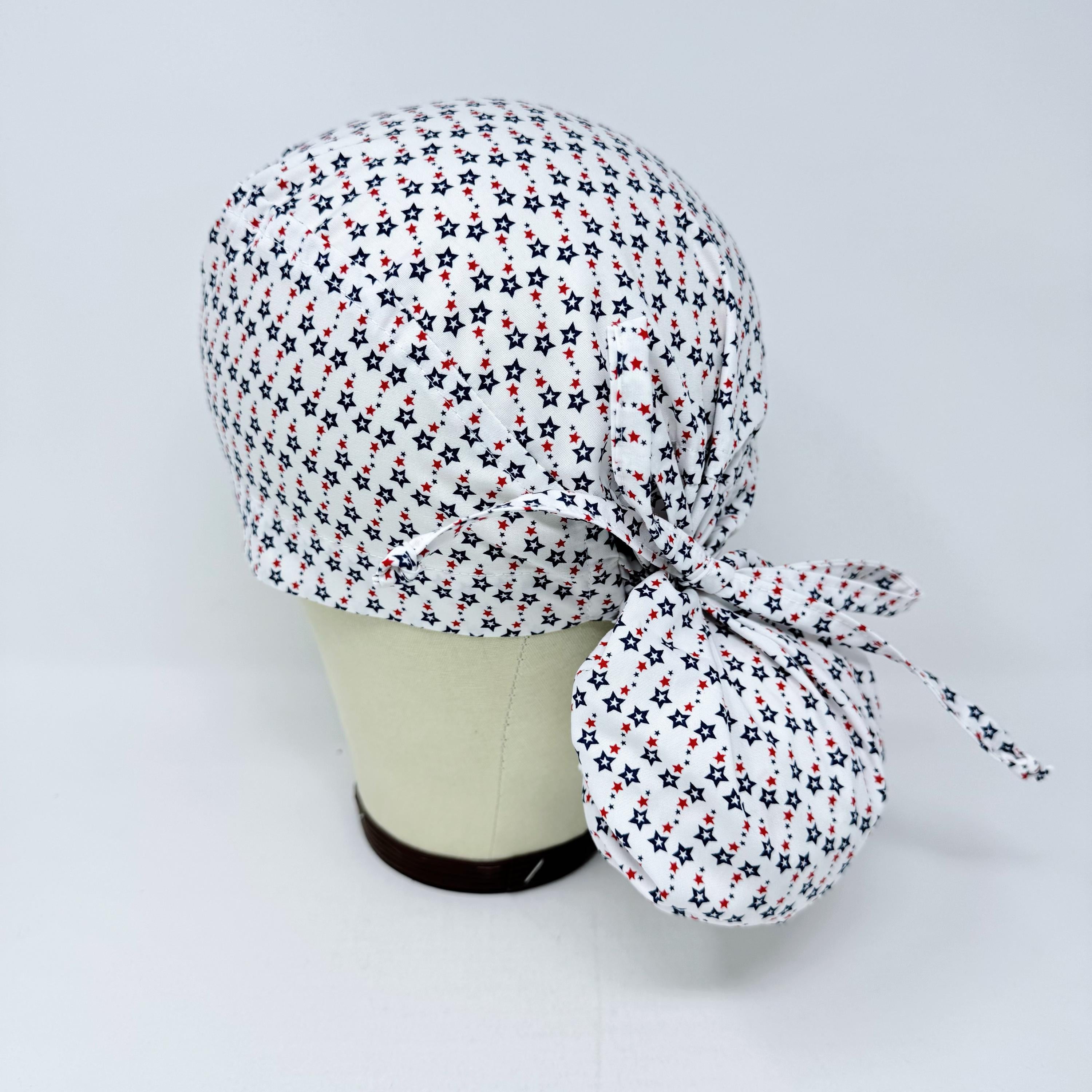 Ponytail scrub cap for women with satin lined option. Patriotic Stars Surgical hat with ponytail by Paradise Caps.