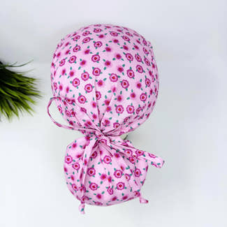 Ponytail scrub cap for women. Pink Floral Scrub hat for women with satin lined option by Paradise Caps.