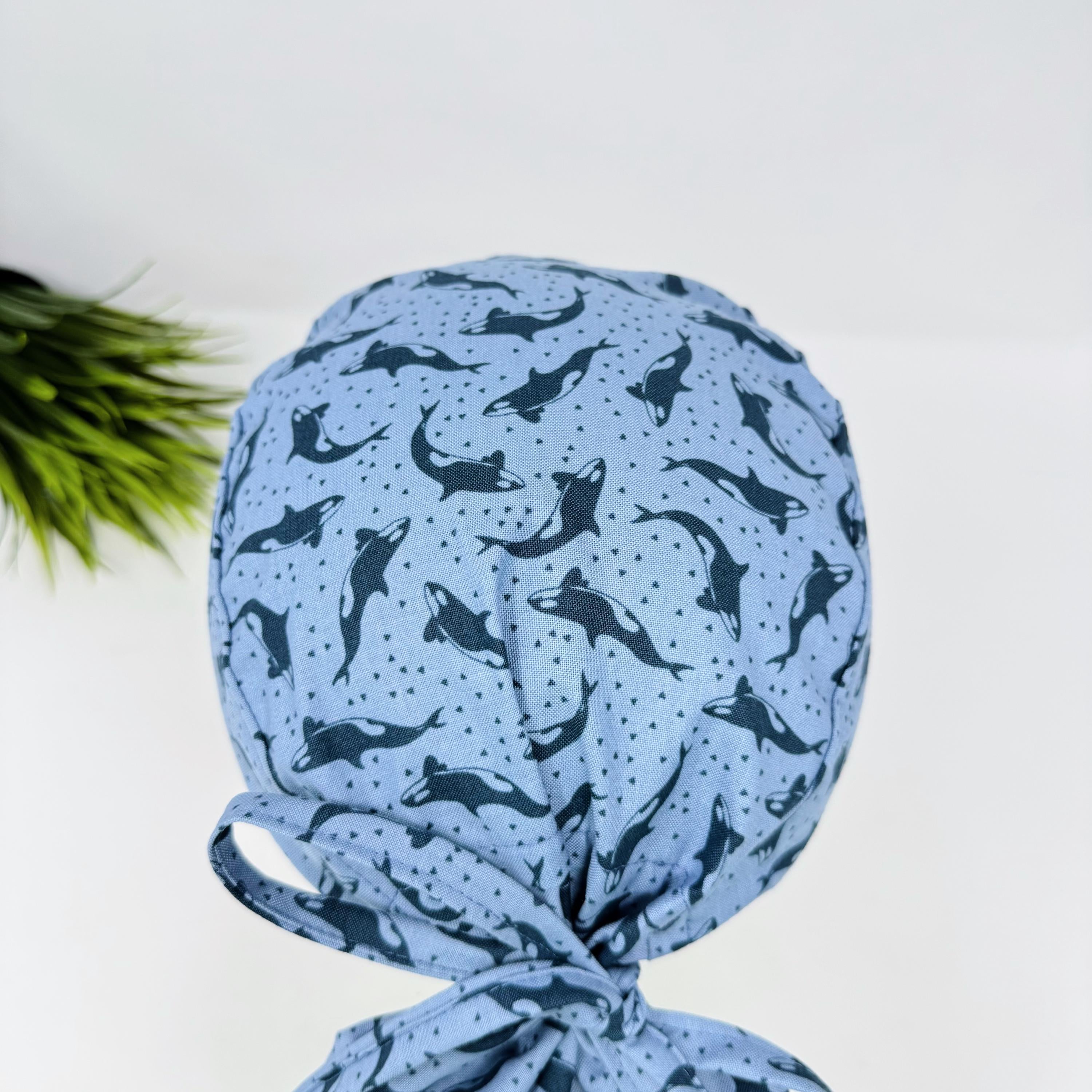 Ocean Orcas ponytail scrub cap women. Satin Lined option Ponytail scrub hat. Blue Sea Scrub caps for women by Paradise Caps.