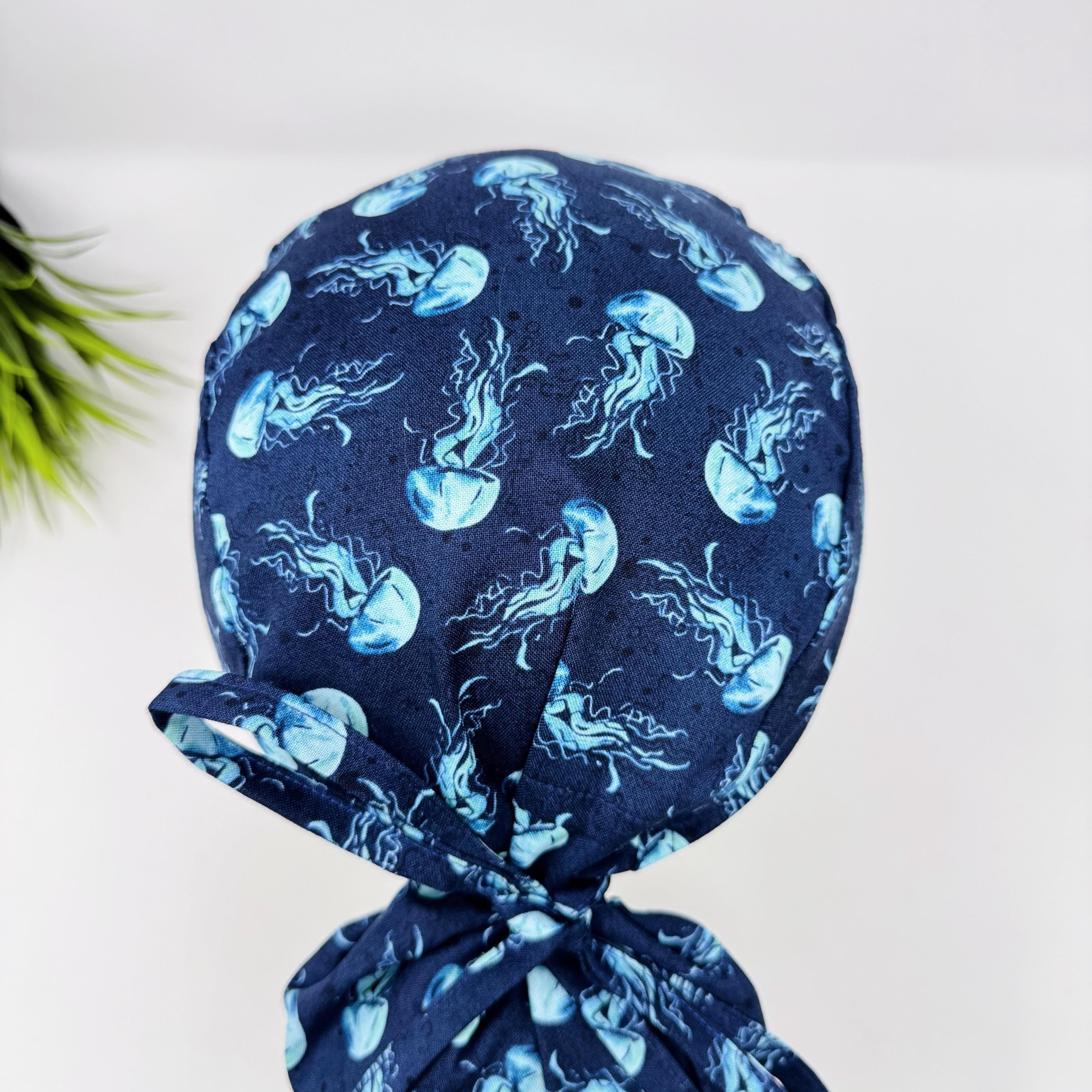 Jellyfish ponytail scrub cap women. Navy Blue Ocean Print Satin Lined option Ponytail scrub hat. Scrub caps for women by Paradise Caps.
