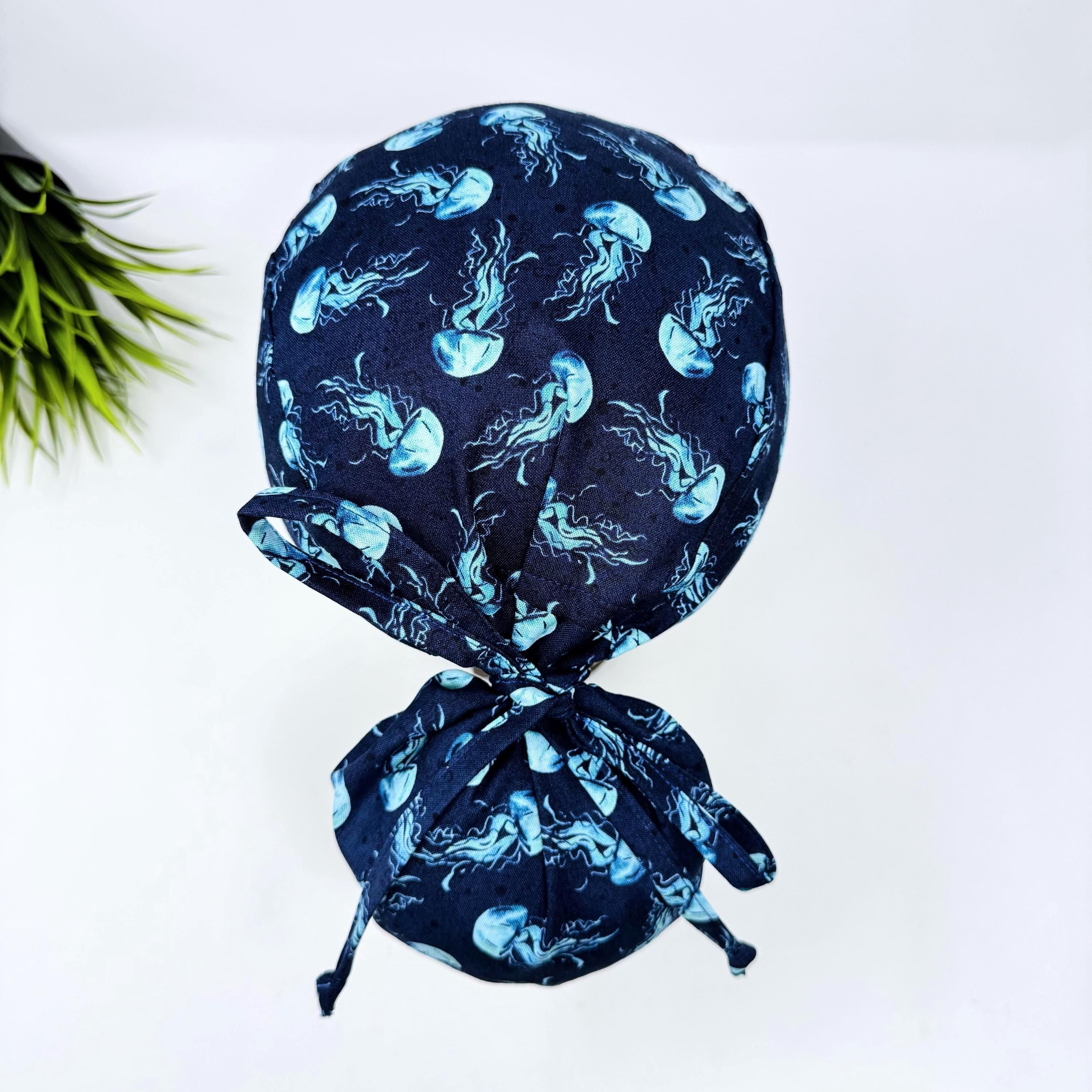 Jellyfish ponytail scrub cap women. Navy Blue Ocean Print Satin Lined option Ponytail scrub hat. Scrub caps for women by Paradise Caps.