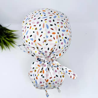 Ponytail surgical scrub cap for women. Spring Petals Scrub hat for women with satin lined option by Paradise Caps.