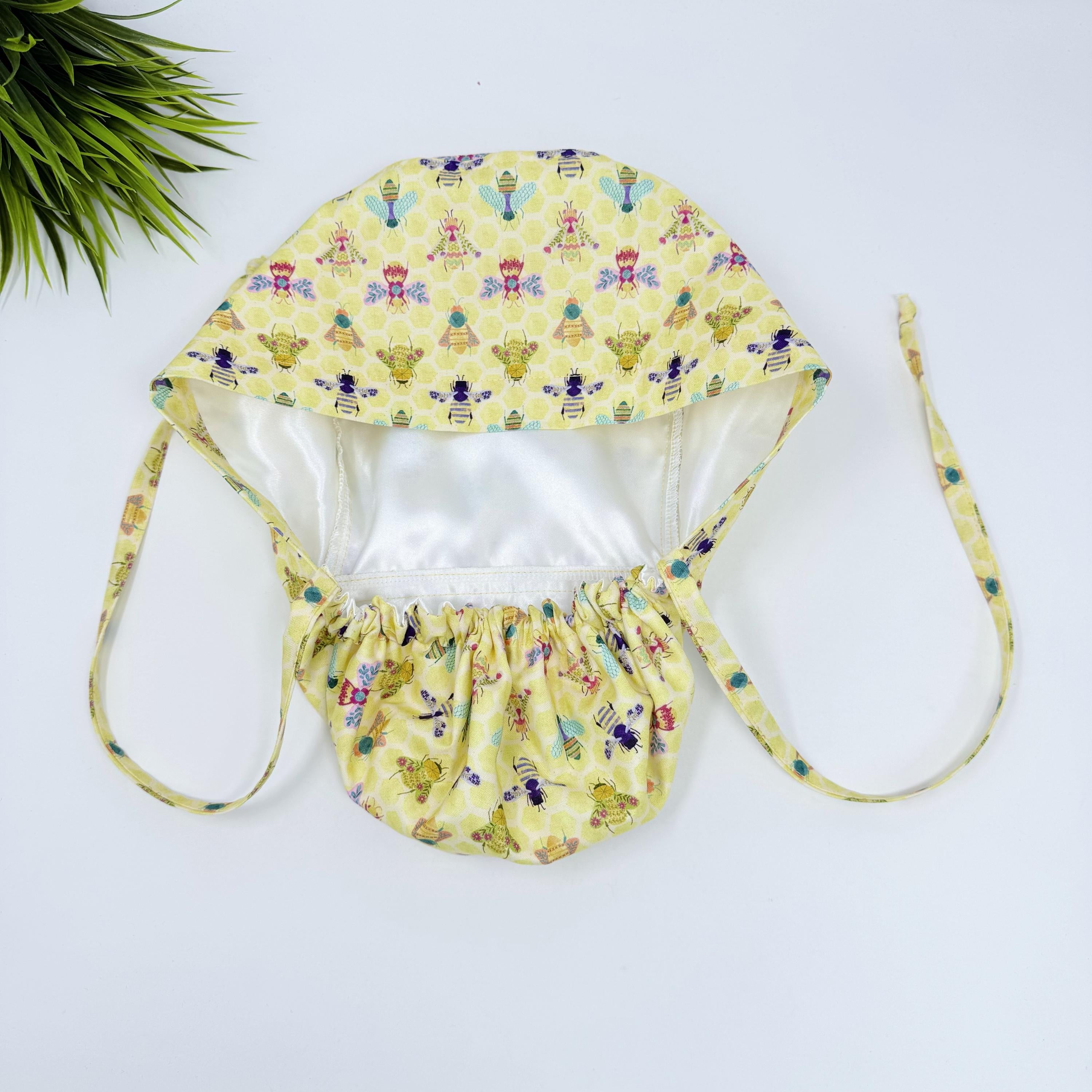 Bee Ponytail scrub cap for women with satin lined option, Yellow Surgical cap with ponytail by Paradise Caps.