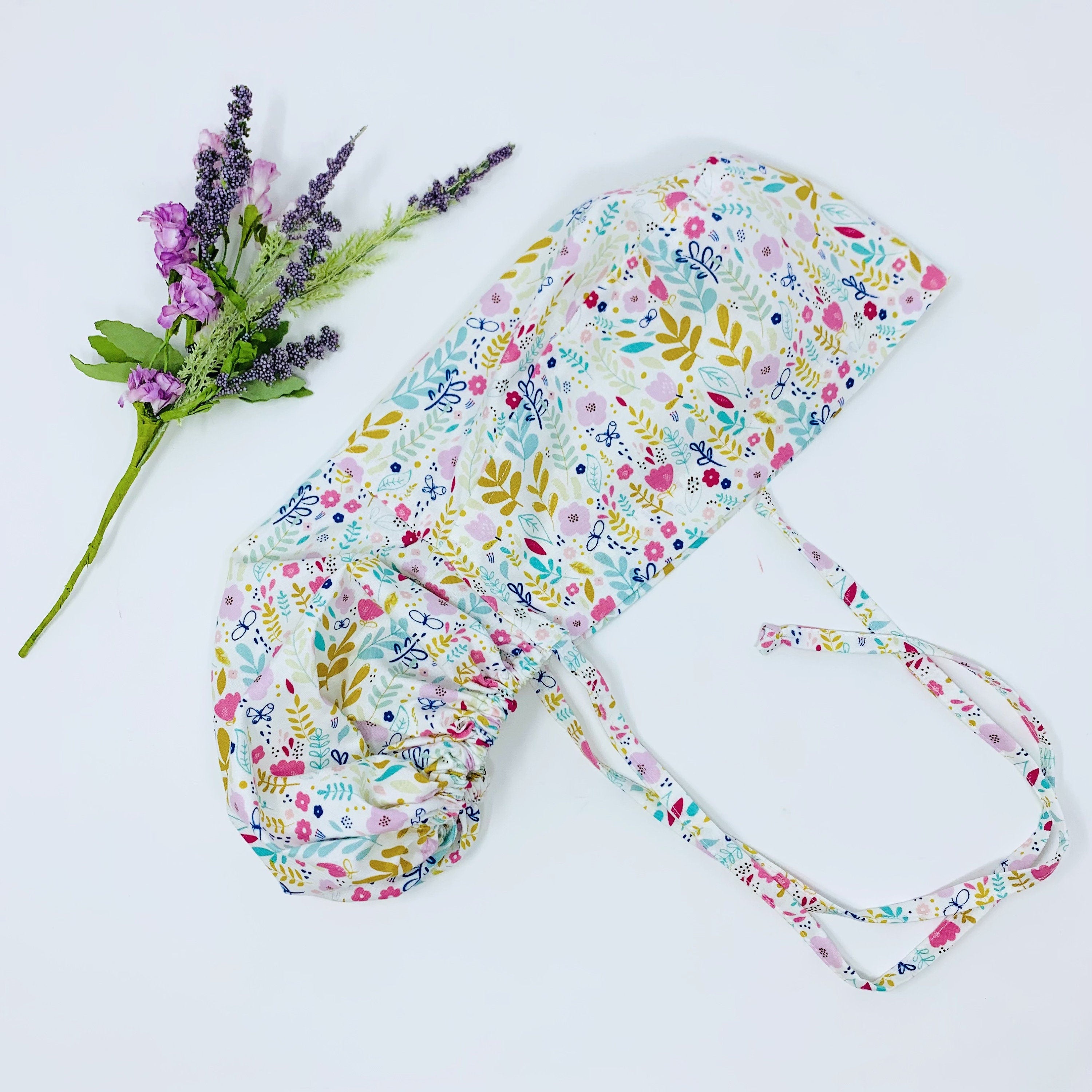 Flowers Ponytail scrub cap for women with satin lined option by Paradise Caps.