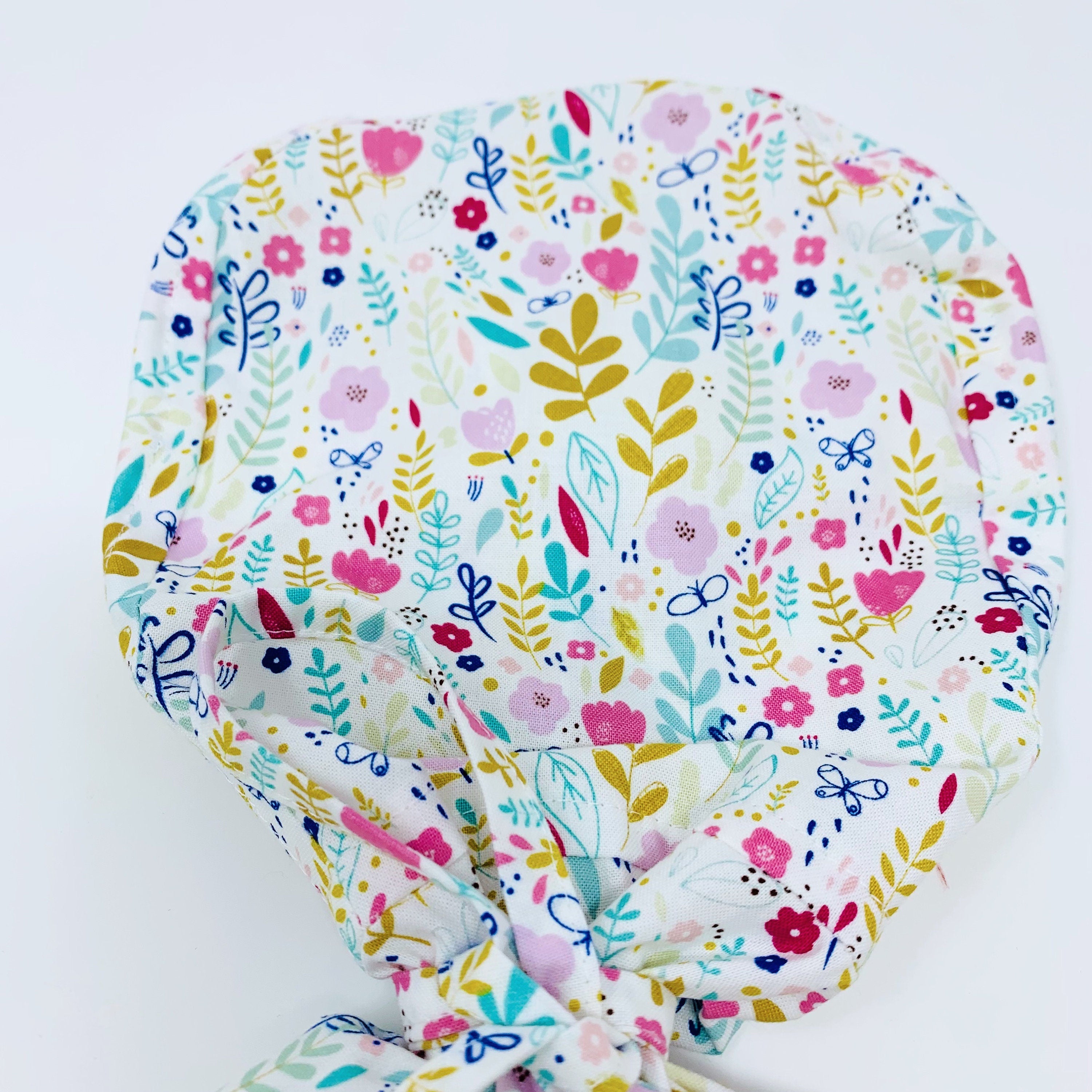 Flowers Ponytail scrub cap for women with satin lined option by Paradise Caps.