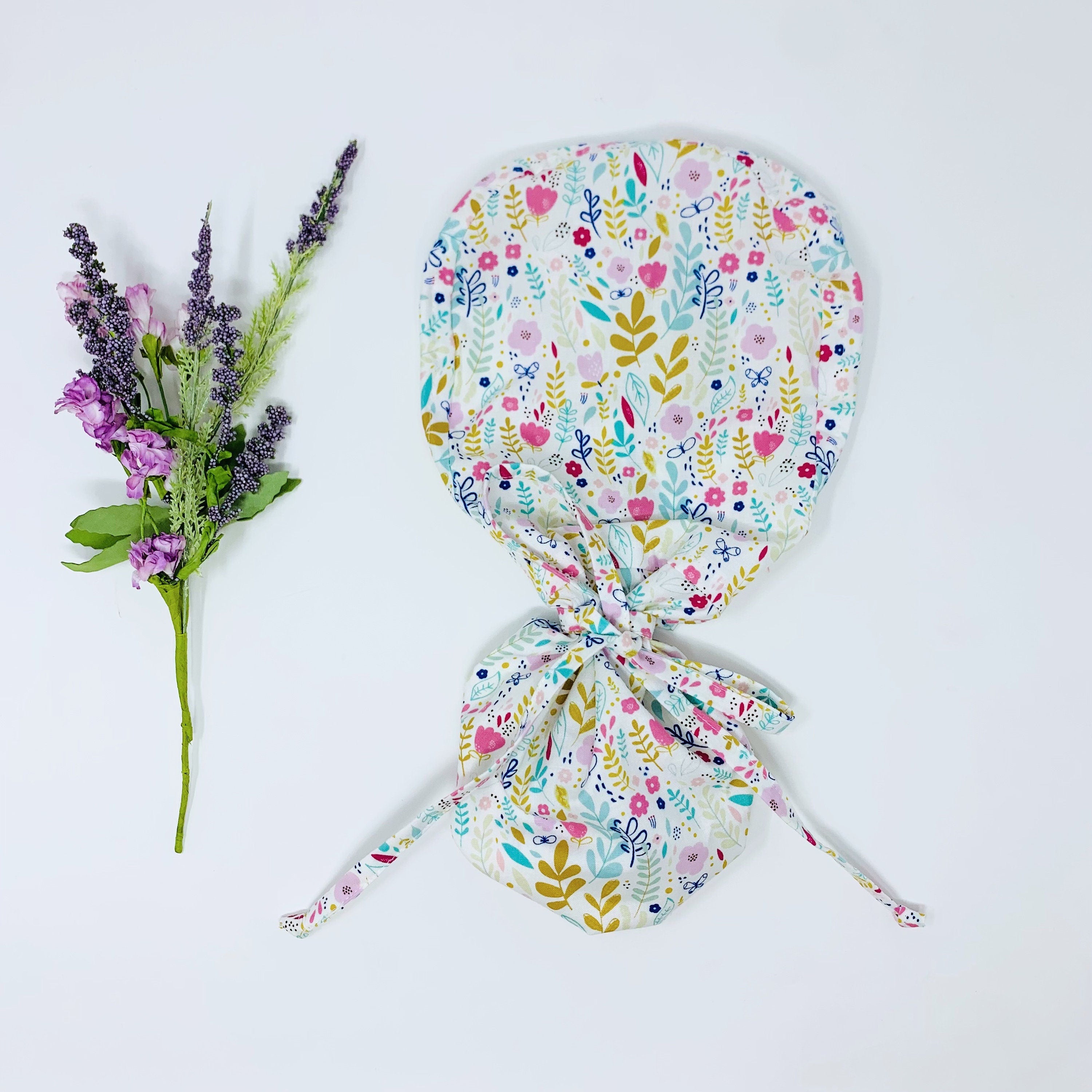 Flowers Ponytail scrub cap for women with satin lined option by Paradise Caps.