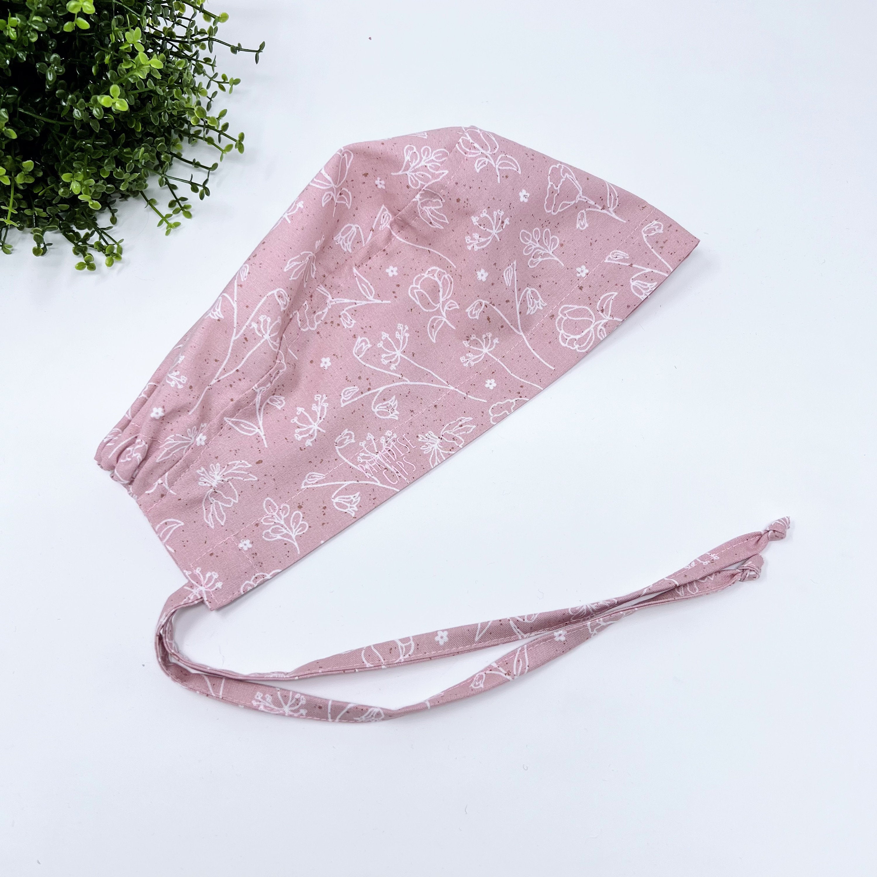 Pink and white Skull tie-back style surgical scrub cap for men by Paradise Caps.