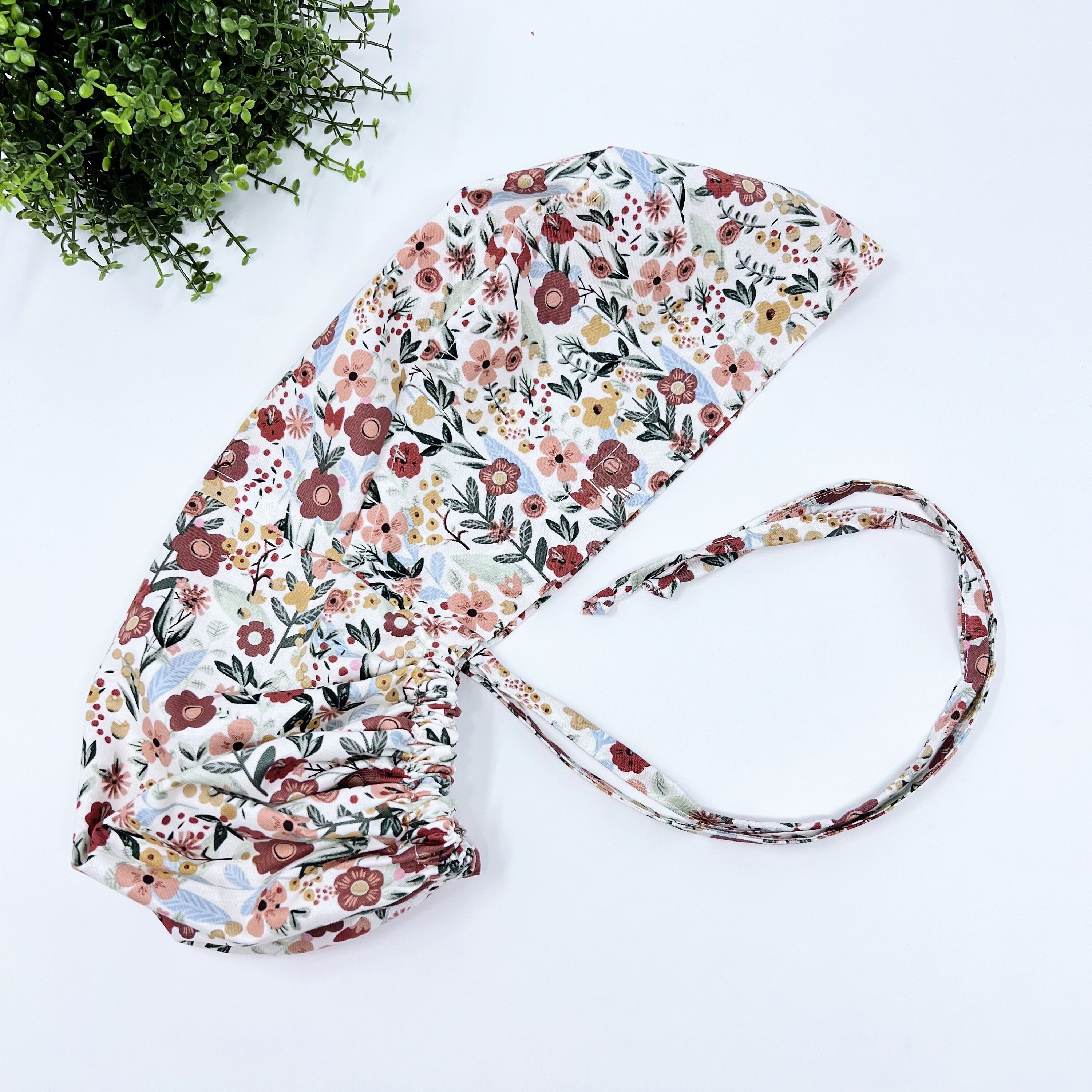 Floral Ponytail scrub cap for women with satin lined option by Paradise Caps.
