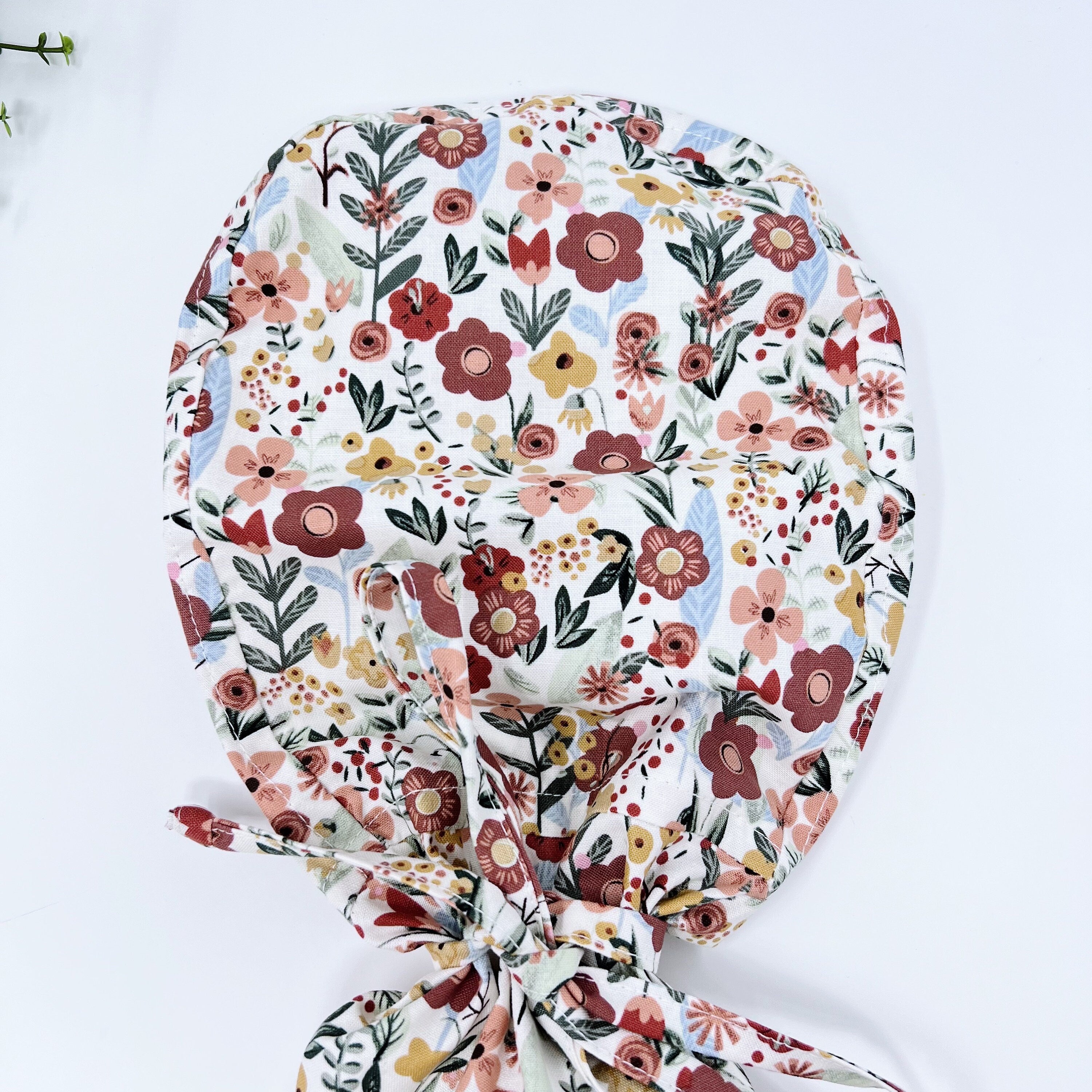 Floral Ponytail scrub cap for women with satin lined option by Paradise Caps.