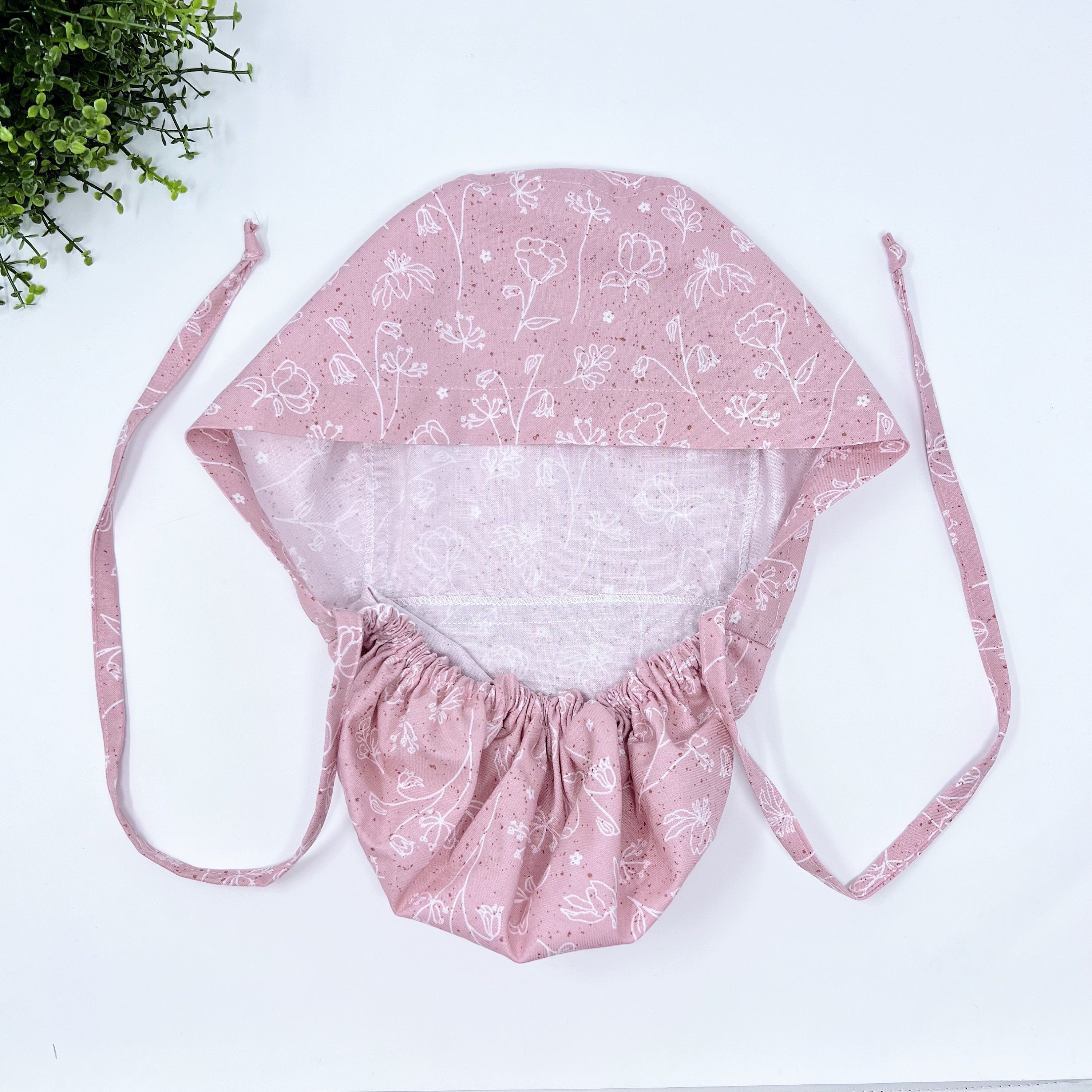 Pink and white Ponytail scrub cap for women with satin lined option by Paradise Caps.