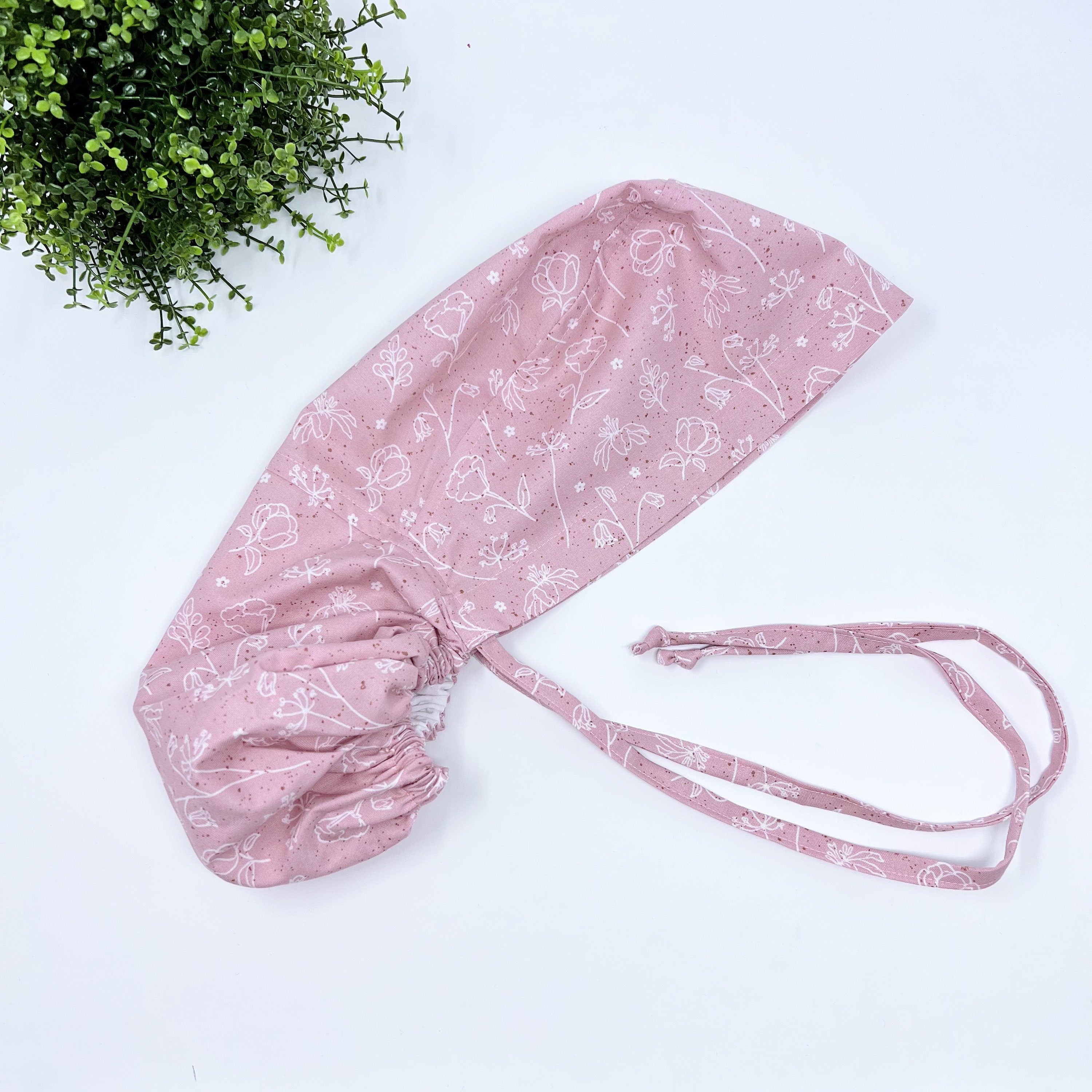 Pink and white Ponytail scrub cap for women with satin lined option by Paradise Caps.