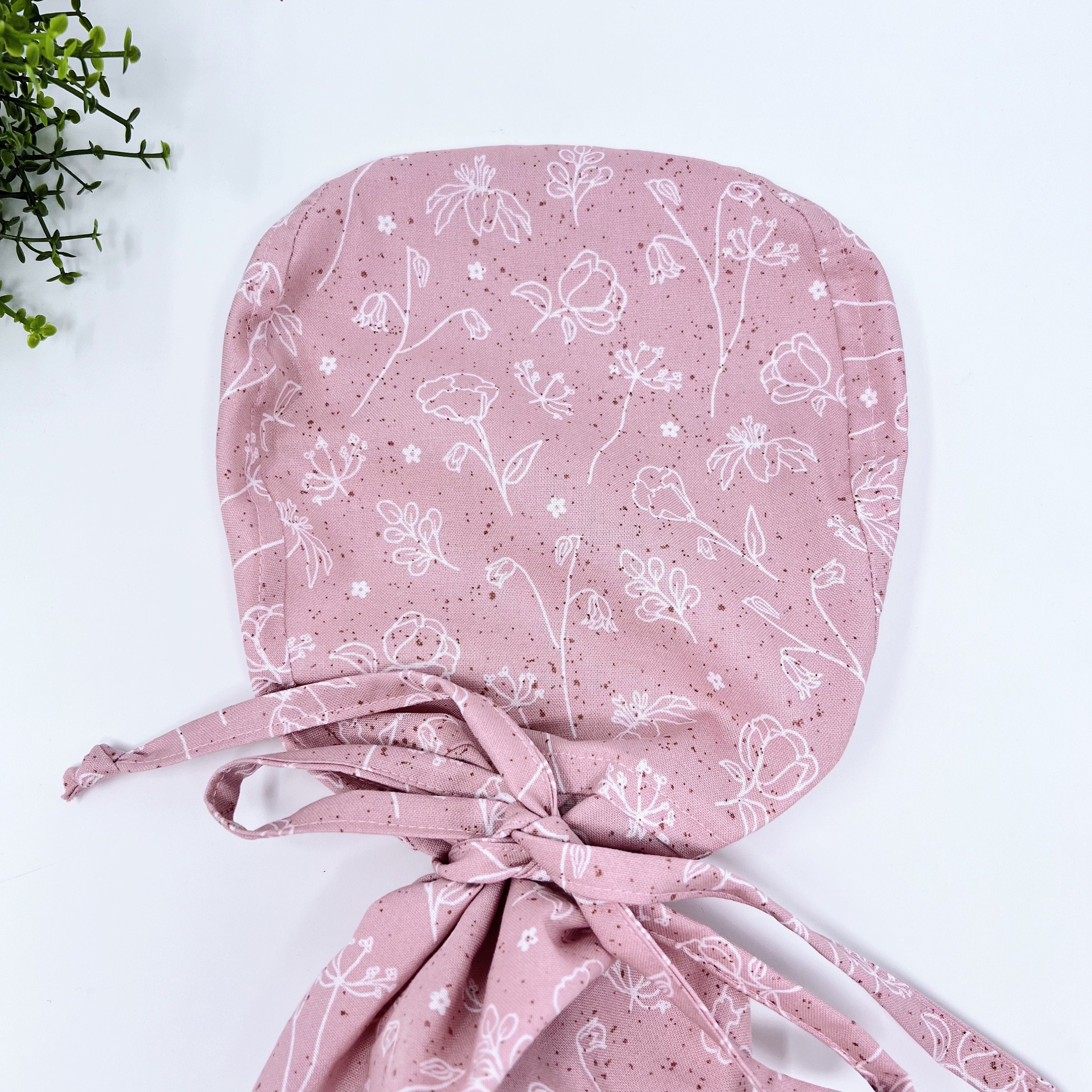 Pink and white Ponytail scrub cap for women with satin lined option by Paradise Caps.