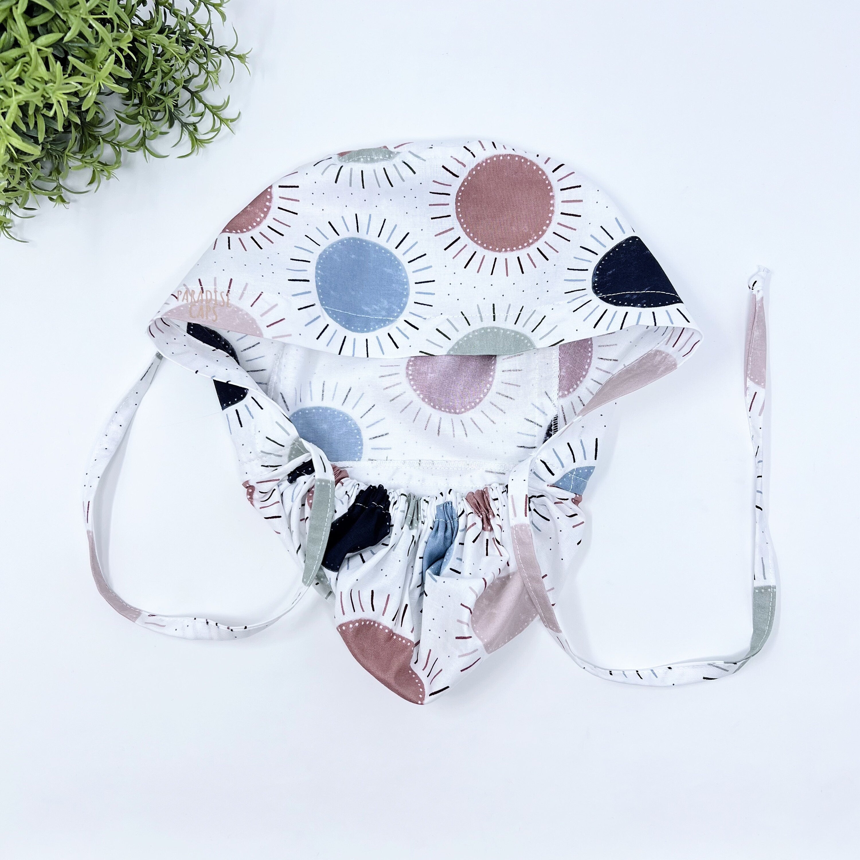 Navy & Coral Suns Ponytail scrub cap for women with satin lined option by Paradise Caps.