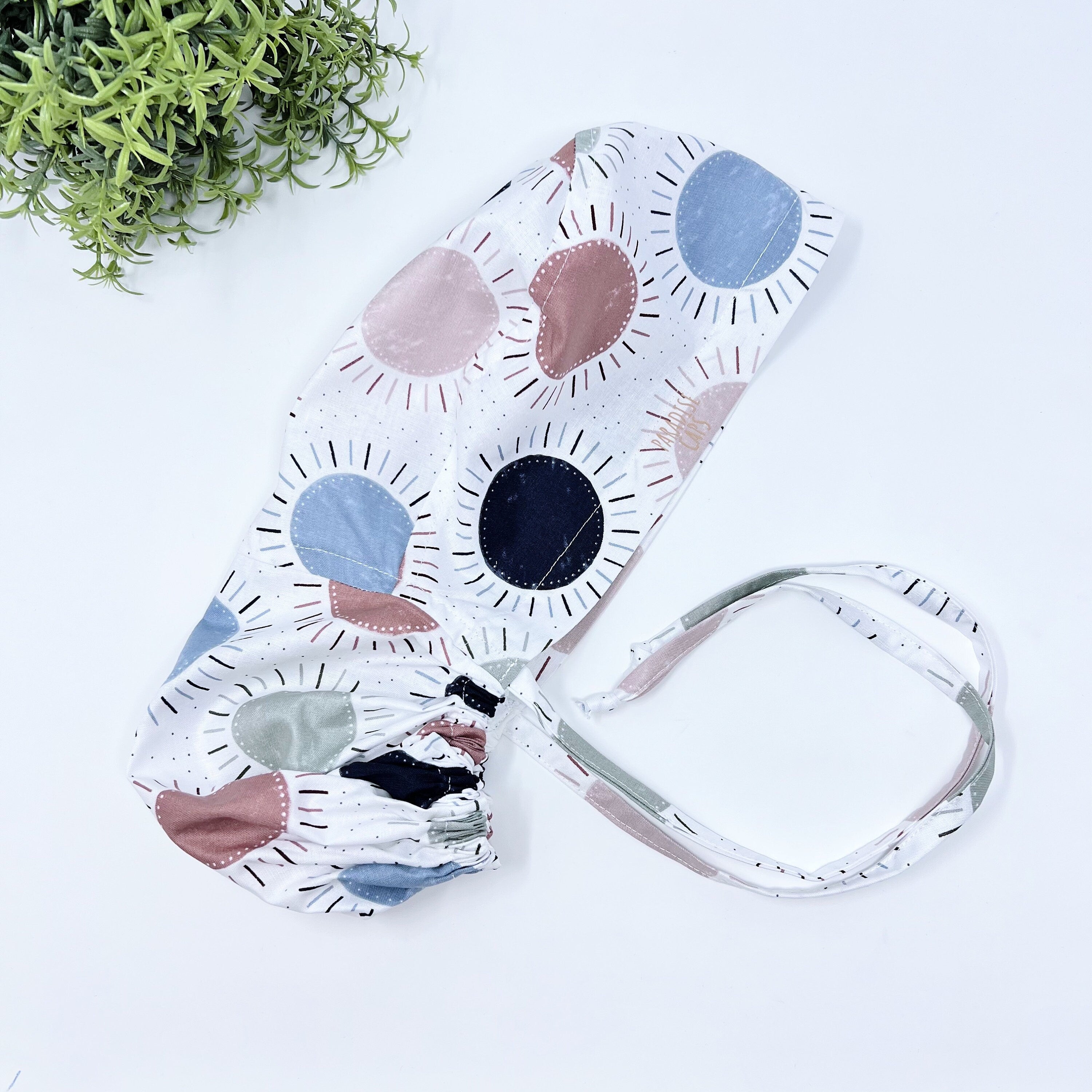 Navy & Coral Suns Ponytail scrub cap for women with satin lined option by Paradise Caps.