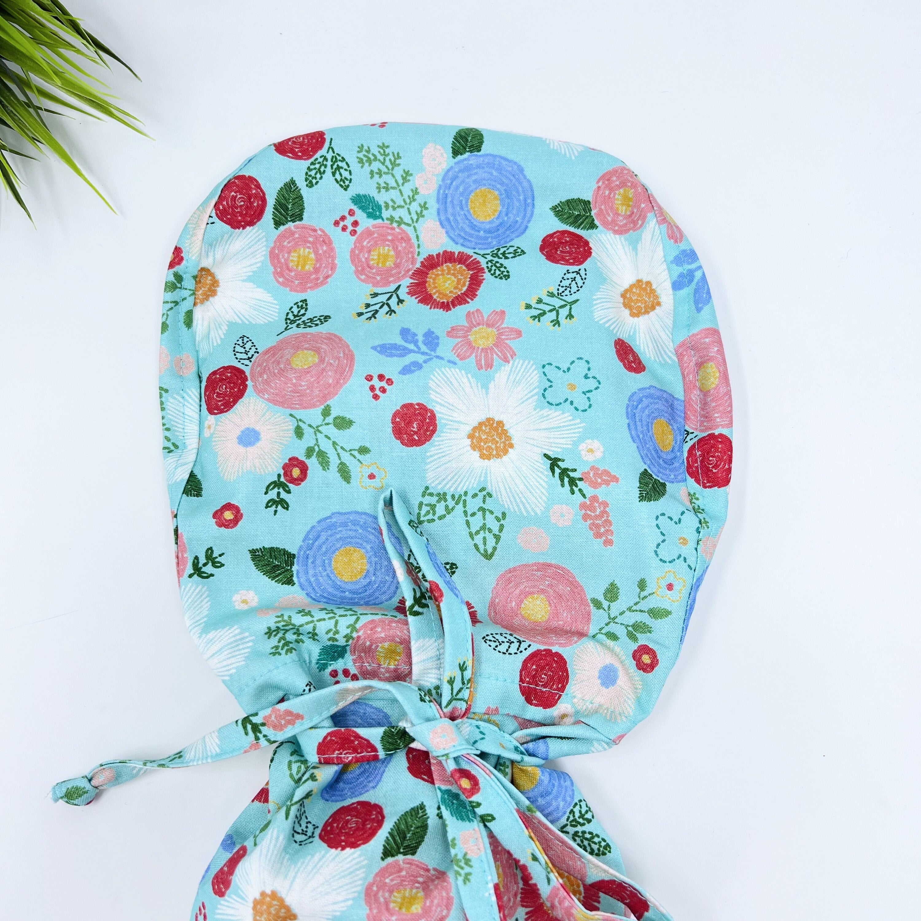 Green floral Ponytail scrub cap for women with satin lined option by Paradise Caps.