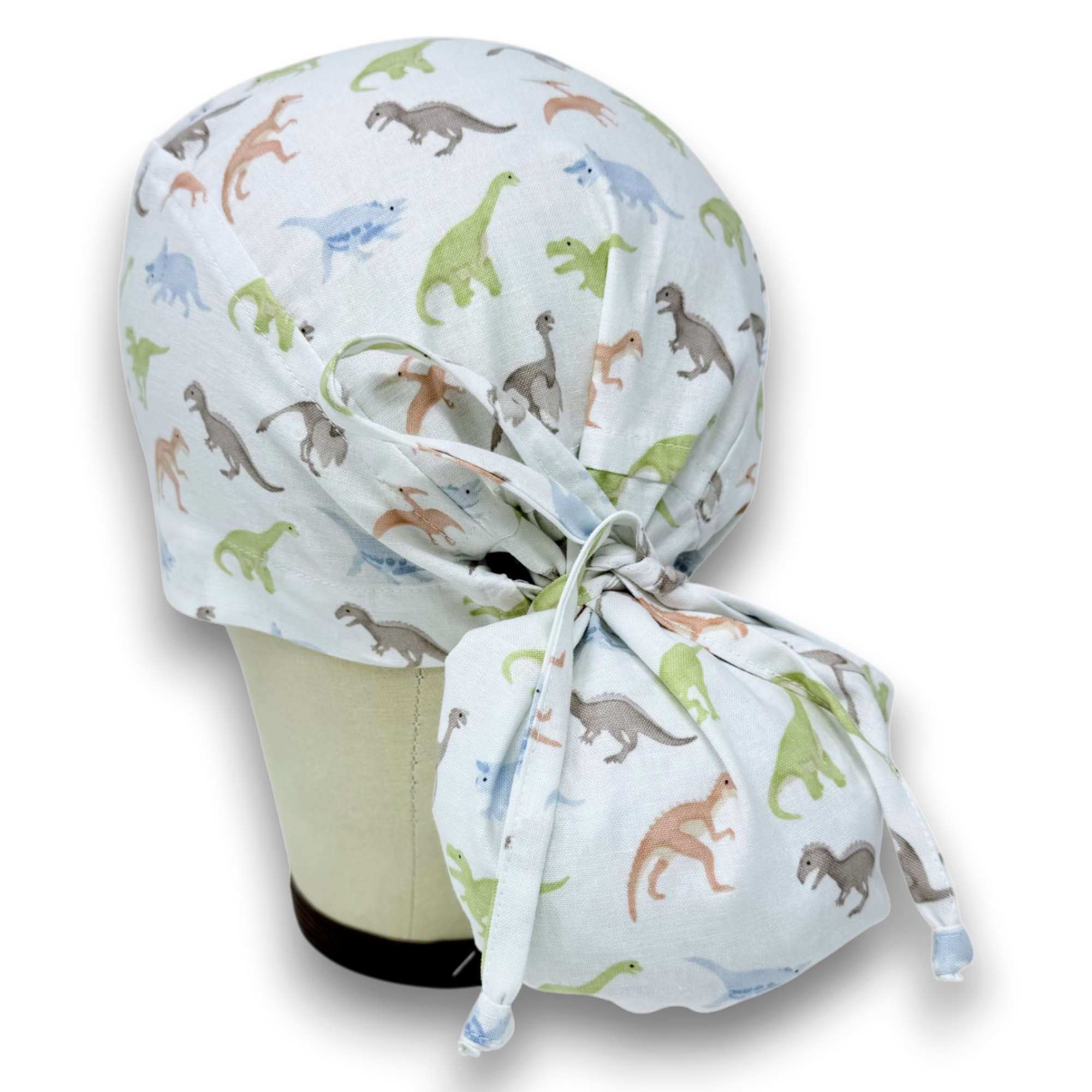 Dino Ponytail scrub cap for women. Dinosaur Surgical hat with satin lined option by Paradise Caps.