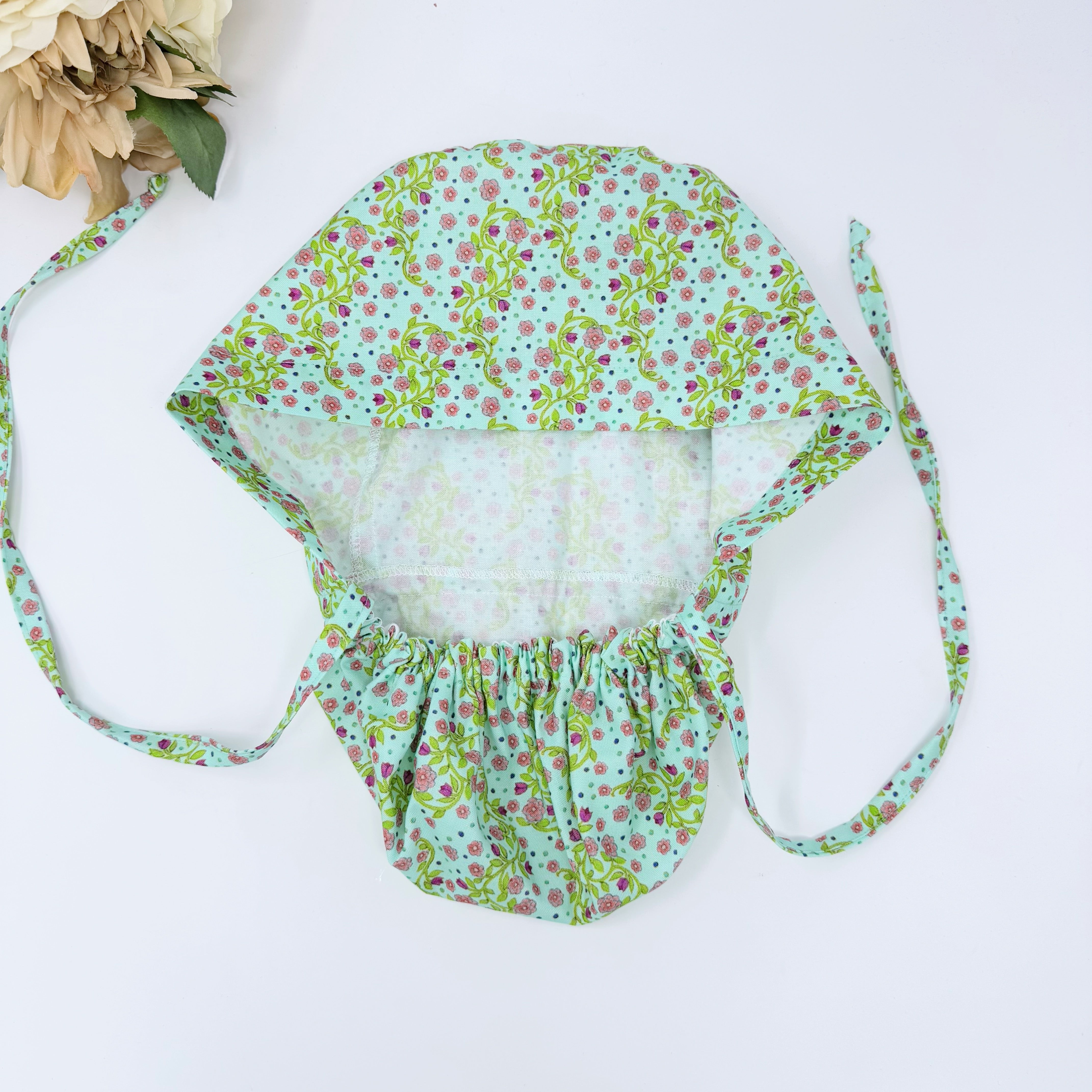 Pink flower Ponytail scrub cap for women with satin lined option by Paradise Caps.