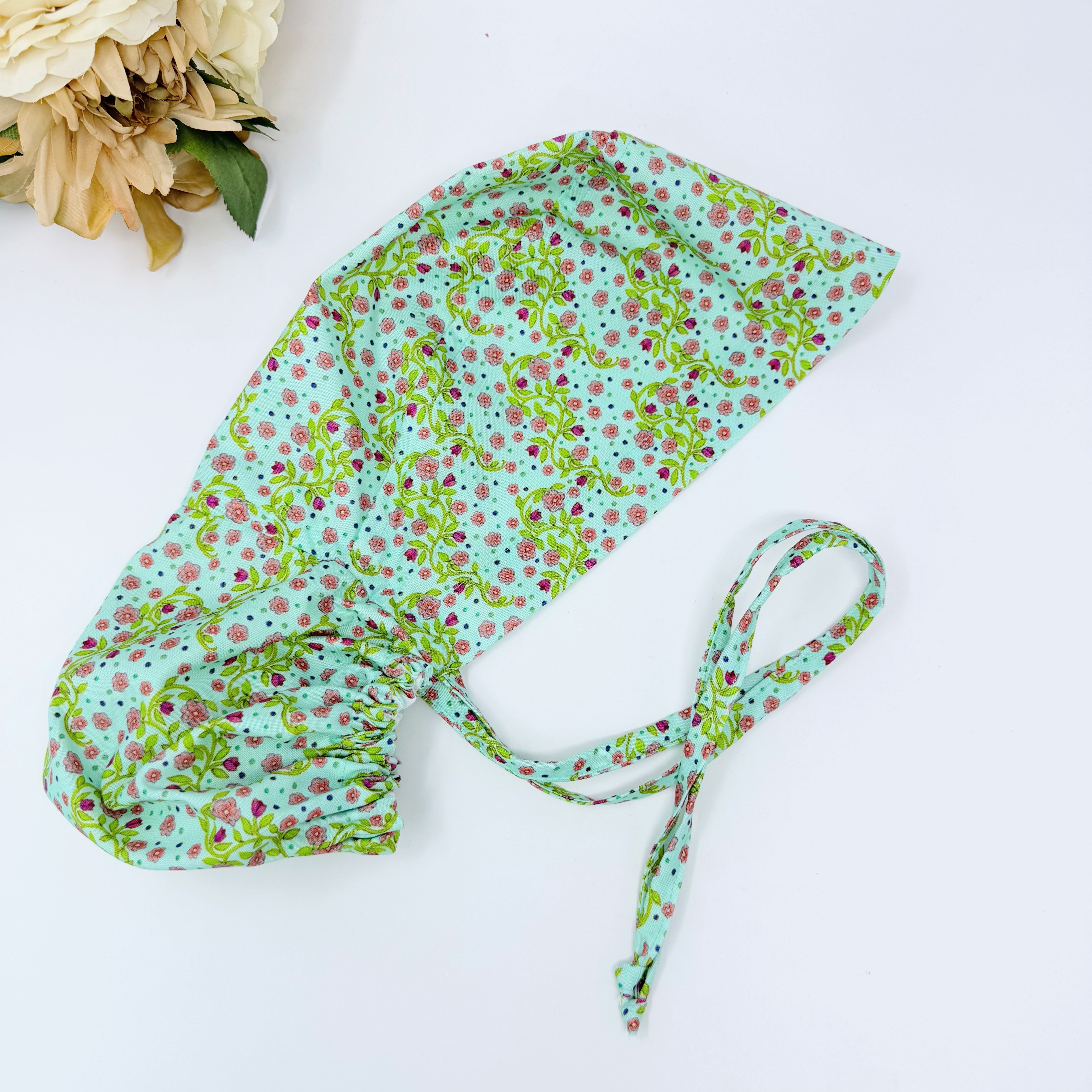 Pink flower Ponytail scrub cap for women with satin lined option by Paradise Caps.