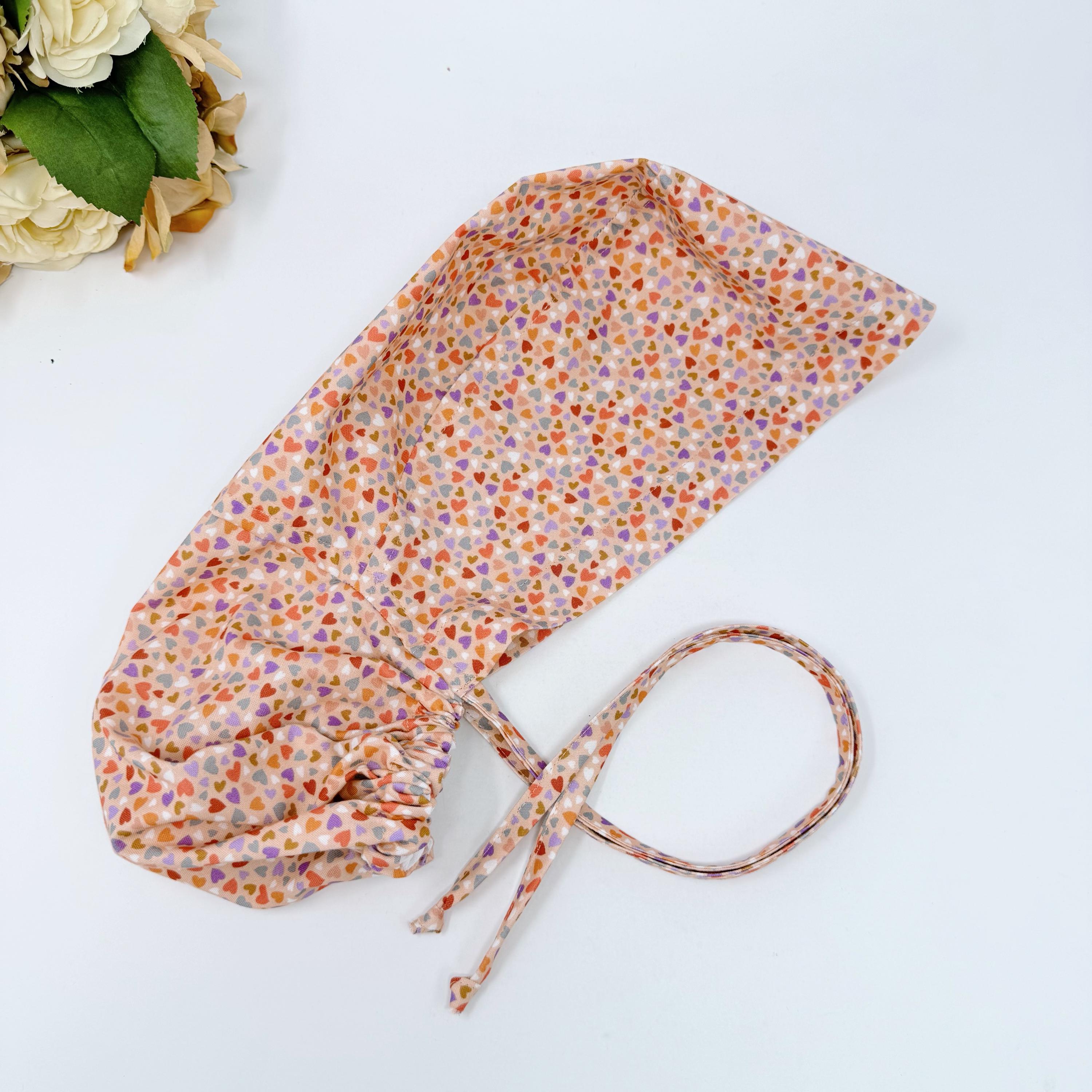 Colorful Hearts Ponytail scrub cap with satin lined. Pink surgical cap for women by Paradise Caps.