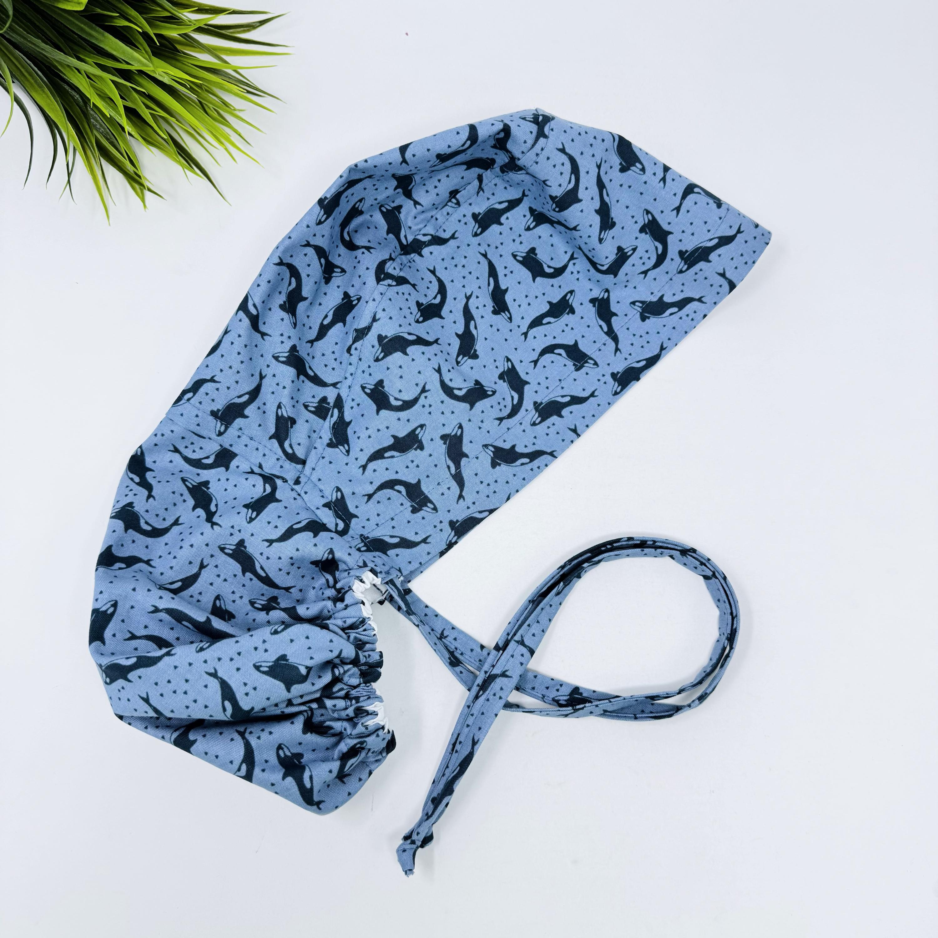 Ocean Orcas ponytail scrub cap women. Satin Lined option Ponytail scrub hat. Blue Sea Scrub caps for women by Paradise Caps.