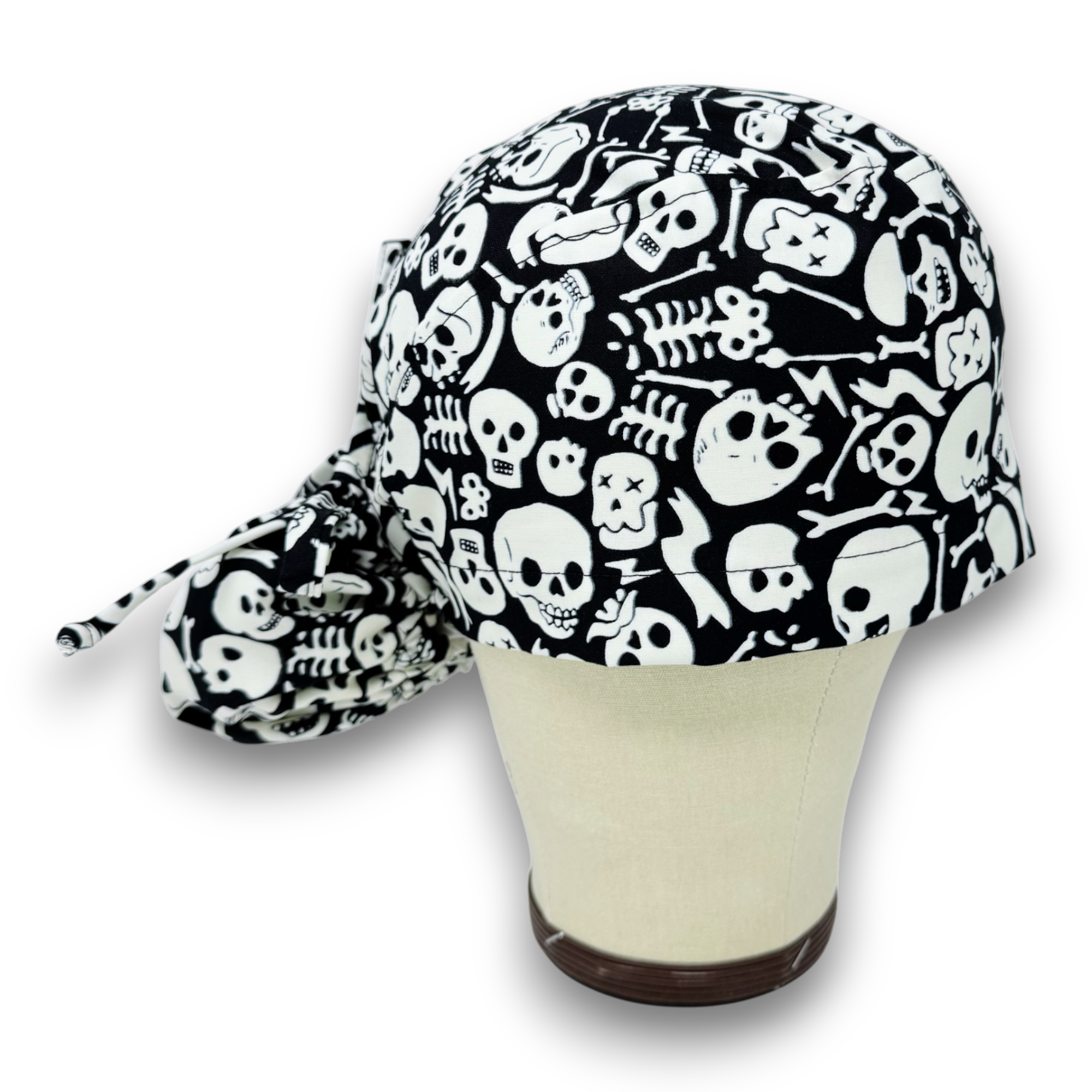 Glow Tossed Skulls Ponytail scrub cap for women with satin lined option by Paradise Caps. Glows in the Dark!