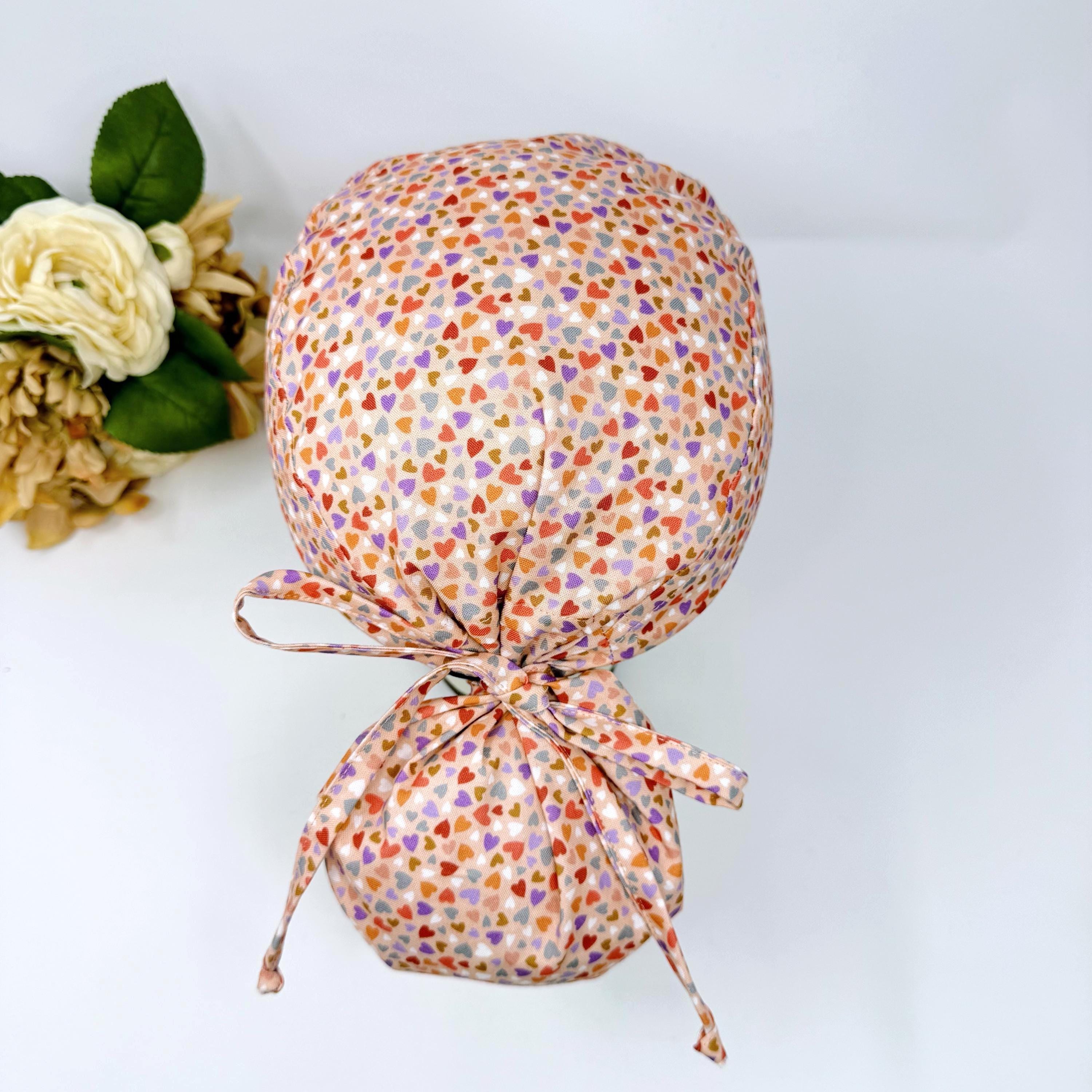 Colorful Hearts Ponytail scrub cap with satin lined. Pink surgical cap for women by Paradise Caps.