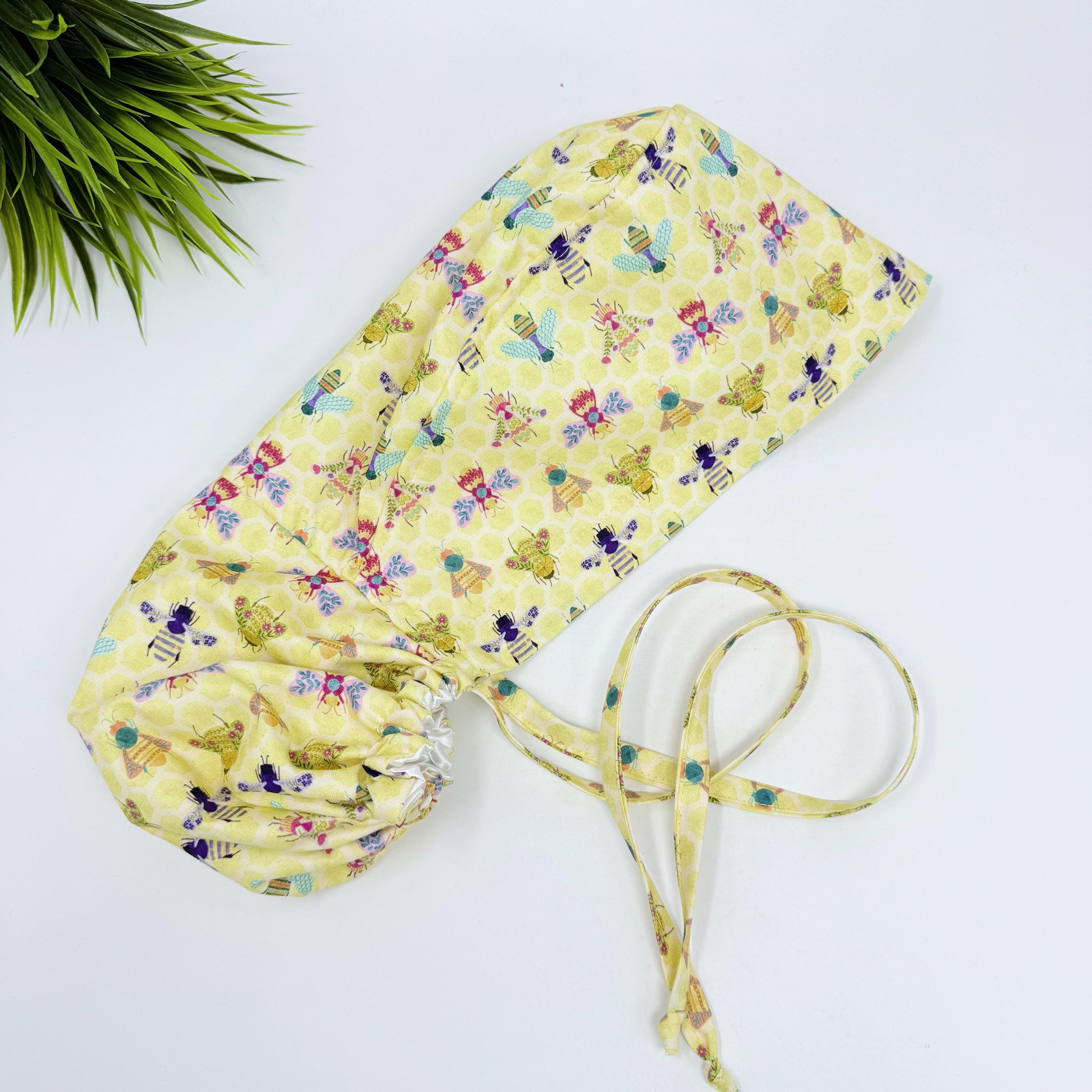 Bee Ponytail scrub cap for women with satin lined option, Yellow Surgical cap with ponytail by Paradise Caps.