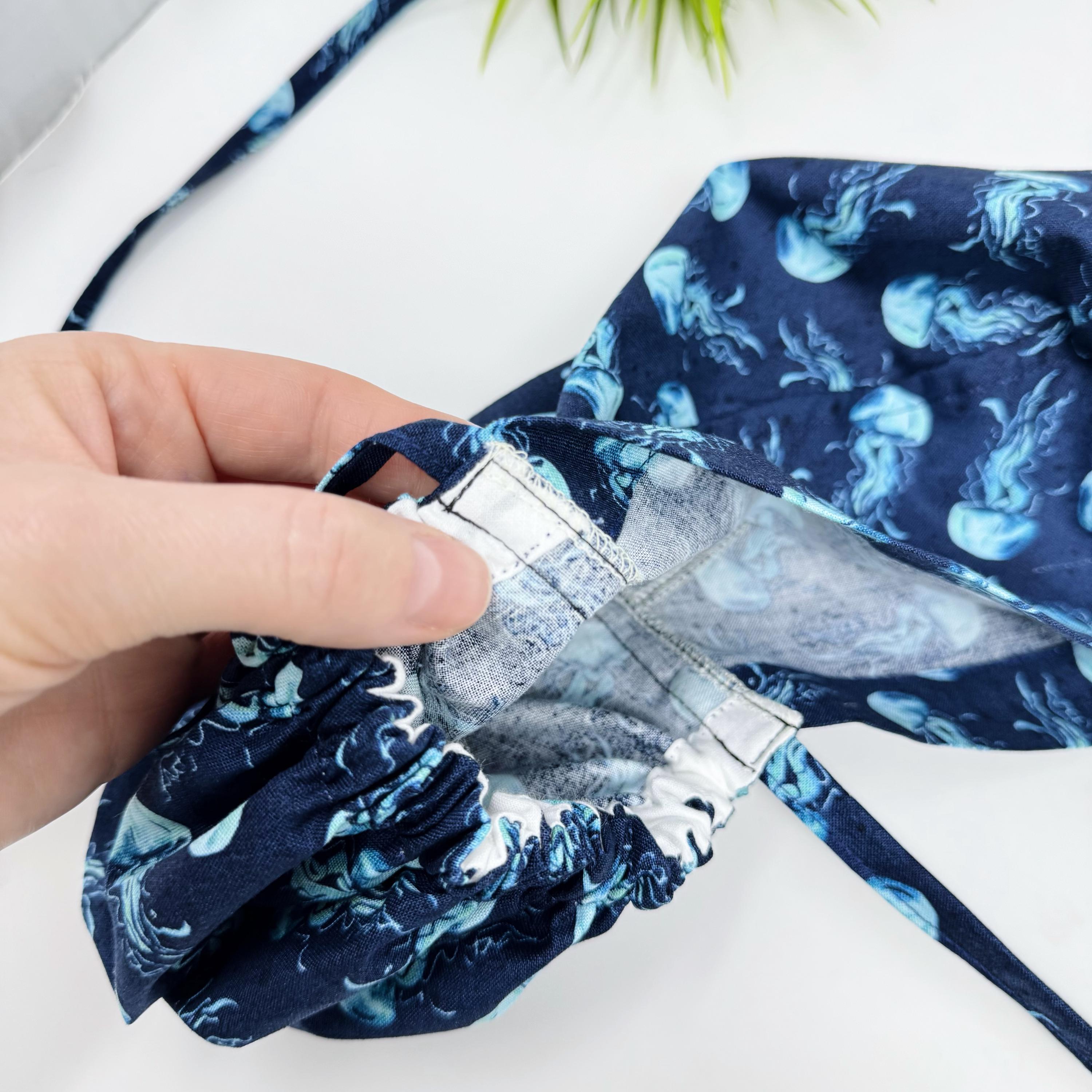 Jellyfish ponytail scrub cap women. Navy Blue Ocean Print Satin Lined option Ponytail scrub hat. Scrub caps for women by Paradise Caps.