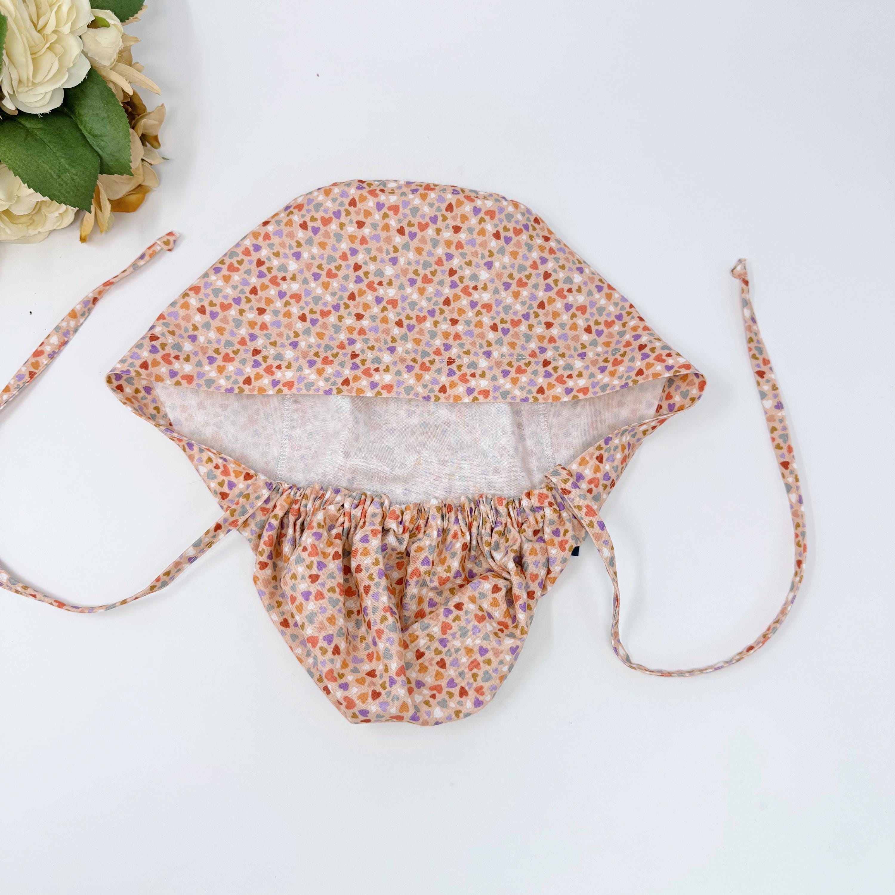Colorful Hearts Ponytail scrub cap with satin lined. Pink surgical cap for women by Paradise Caps.