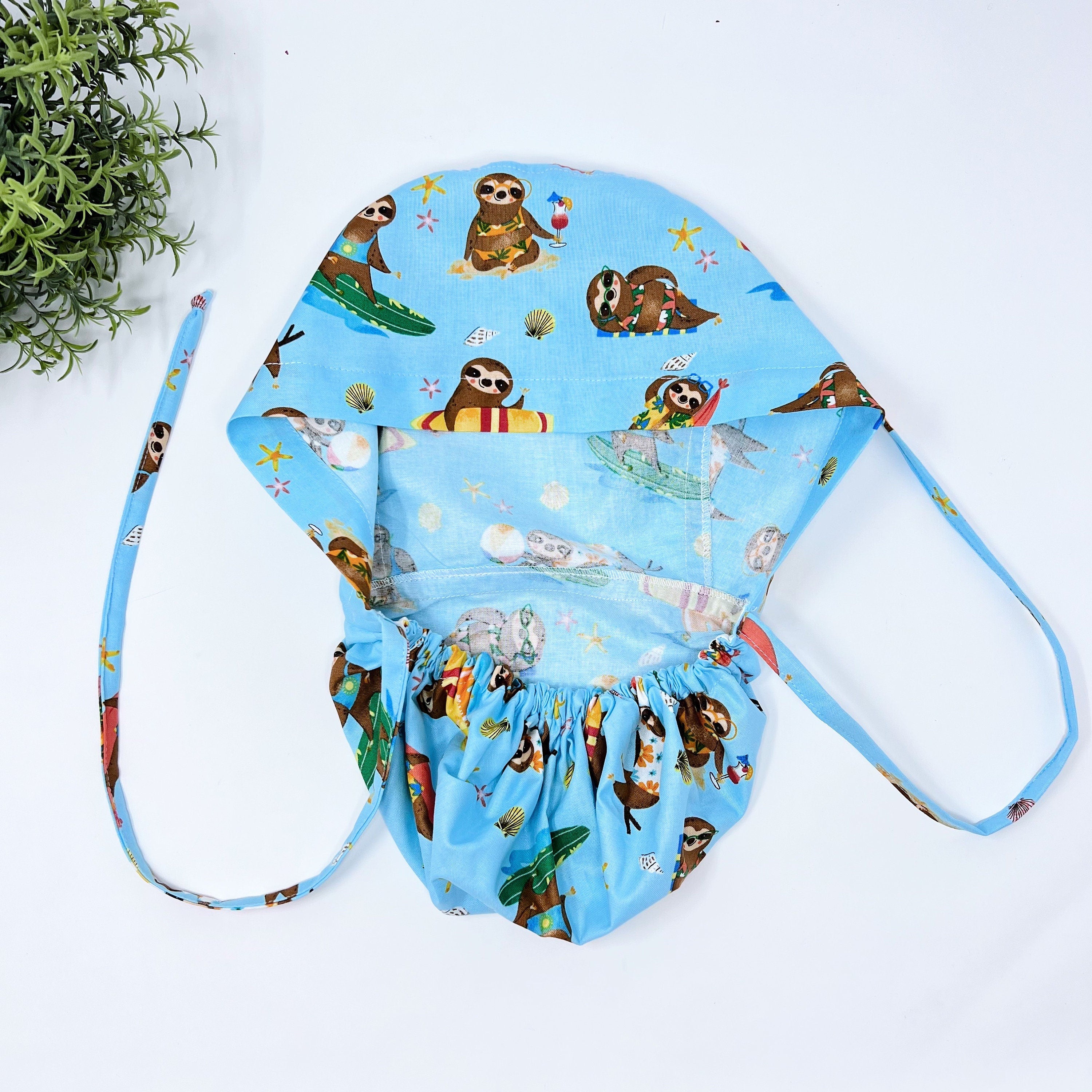 Summer ponytail scrub cap for women. Funny Ponytail scrub hat. Surfing sloths scrub hat with satin lined option by Paradise Caps.